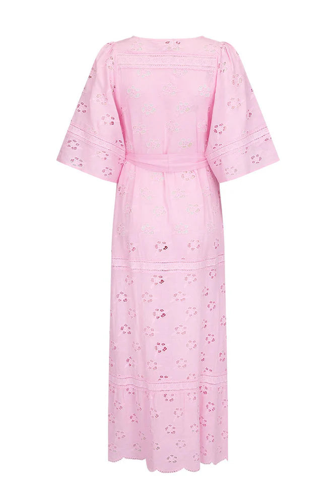 Step into a daydream with the Love Note Broderie Gown in Cosmos Pink, a gown that speaks of romance and delicate femininity. The soft pink hue, combined with custom embroidery and lace, lends an air of whimsy and beauty. A V-neckline with a keyhole opening at the centre front and side splits create a graceful, flowing silhouette, while flutter sleeves add a touch of fairytale magic. 