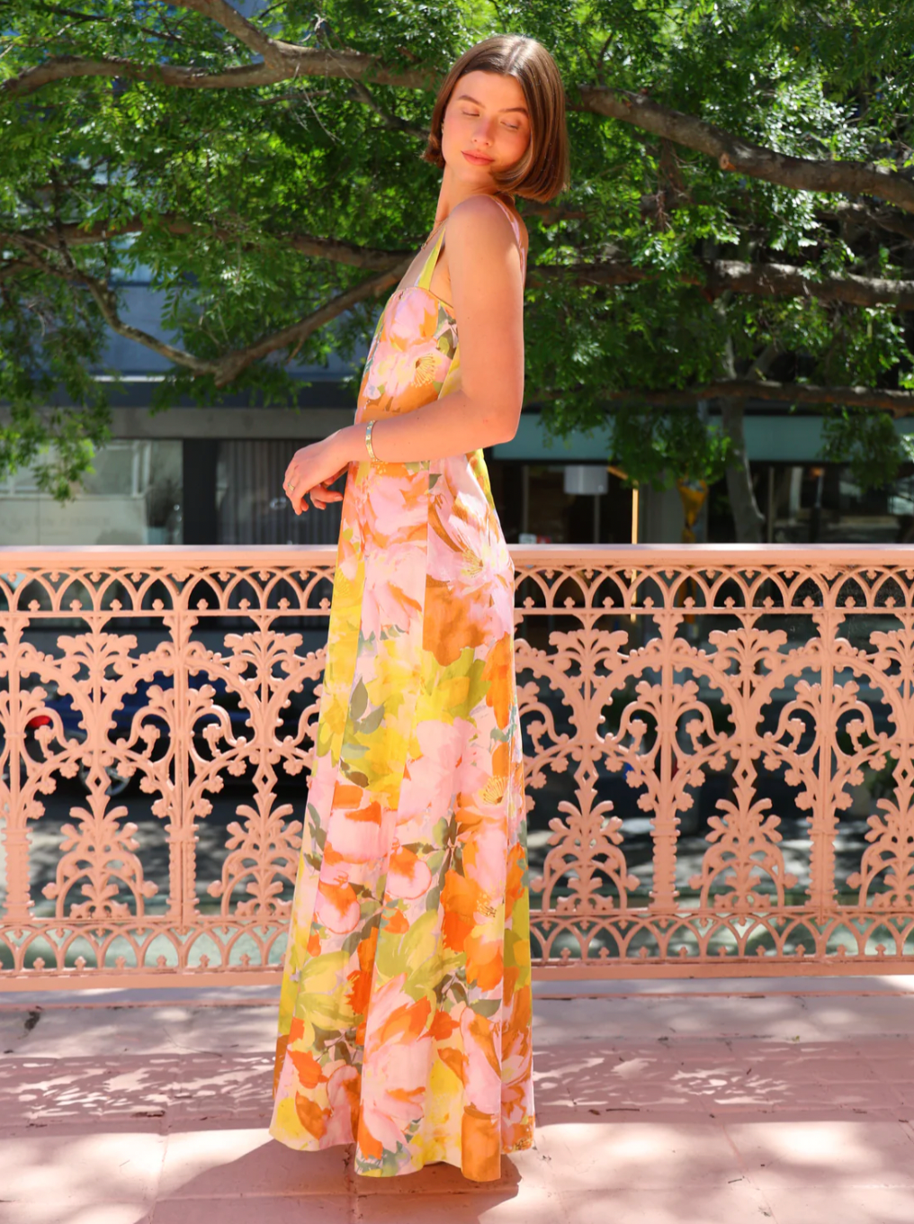 The Goldie Maxi Dress in Floral Confetti by Nicola offers a refined silhouette with a fully lined design and elegant circle skirt for graceful movement. Its wide straps and straight neckline highlight a flattering shape, while the delicate floral confetti pattern adds a soft, romantic touch. Finished with a discreet center-back zip, this dress ensures a seamless fit, making it an ideal choice for garden parties, weddings, or any event where effortless elegance is desired. 