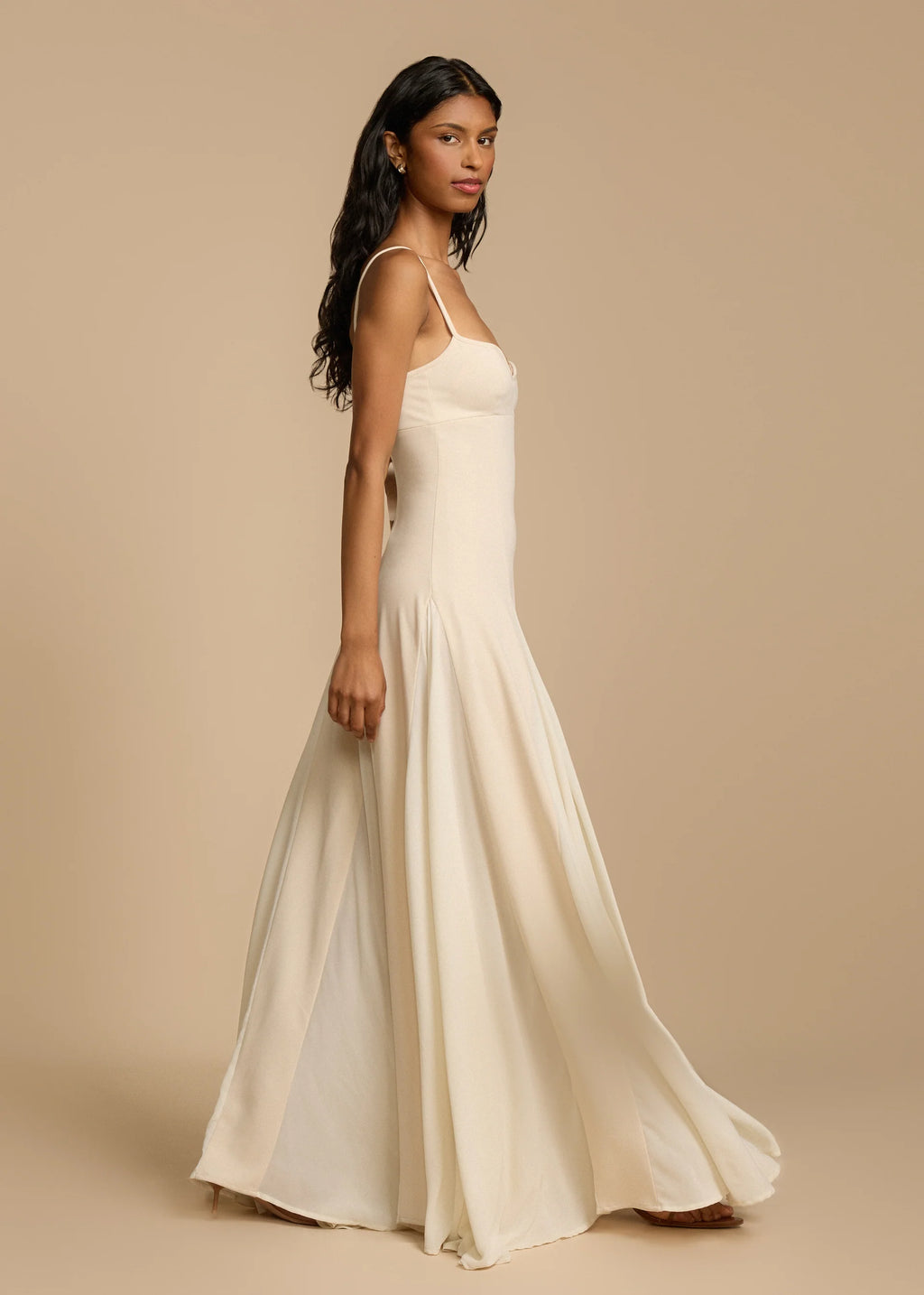 Paloma Dress by Arcina Ori combines classic elegance with modern design, featuring a paneled A-line skirt crafted from white georgette that drapes smoothly off the hips and moves gracefully. Its contrasting accents enhance fluidity, making it ideal for memorable occasions. Equipped with padded bra cups and binded edges, it offers structured support and a flattering silhouette. Paloma delivers refined sophistication and confidence from every perspective.