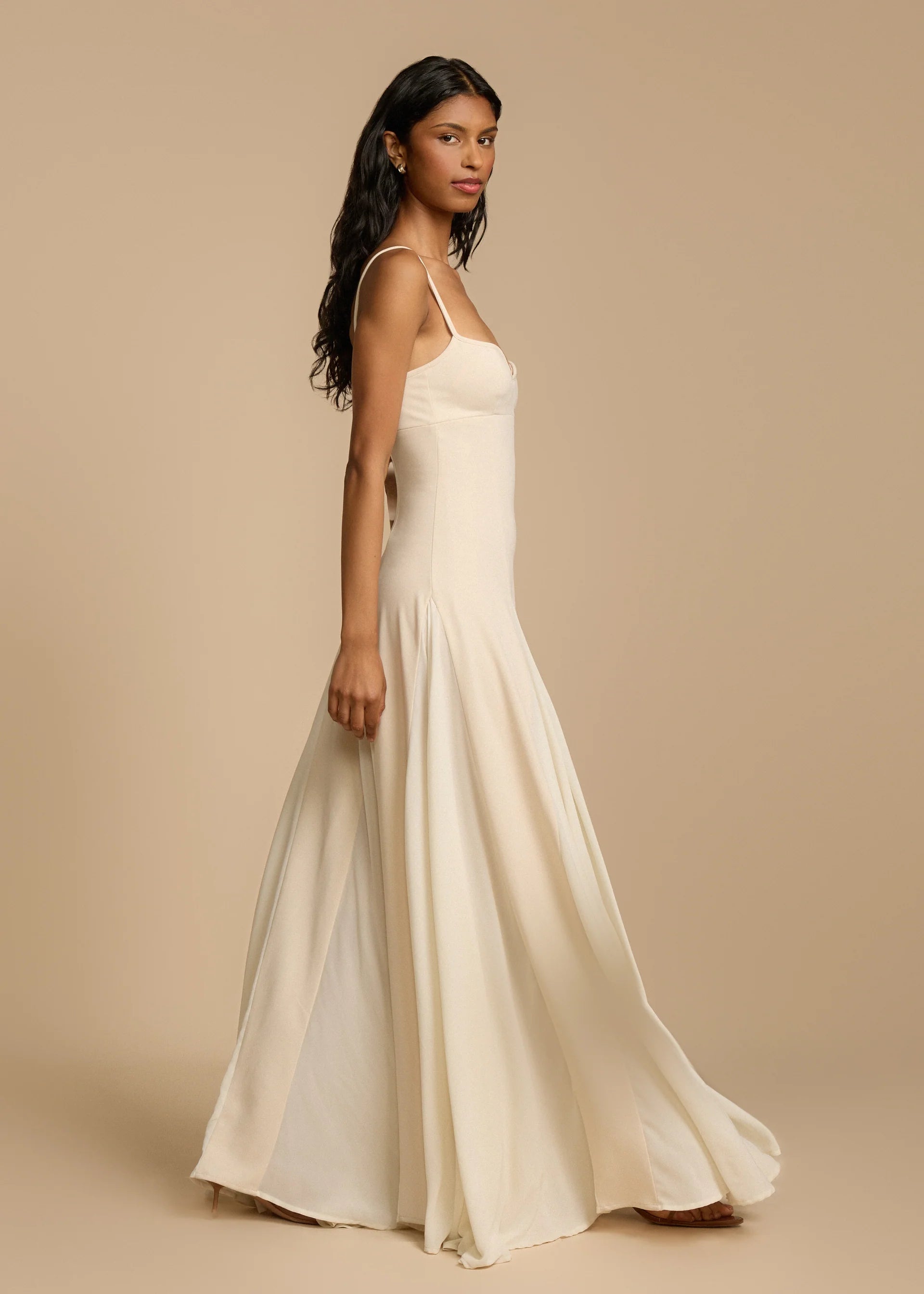 Paloma Dress by Arcina Ori combines classic elegance with modern design, featuring a paneled A-line skirt crafted from white georgette that drapes smoothly off the hips and moves gracefully. Its contrasting accents enhance fluidity, making it ideal for memorable occasions. Equipped with padded bra cups and binded edges, it offers structured support and a flattering silhouette. Paloma delivers refined sophistication and confidence from every perspective.