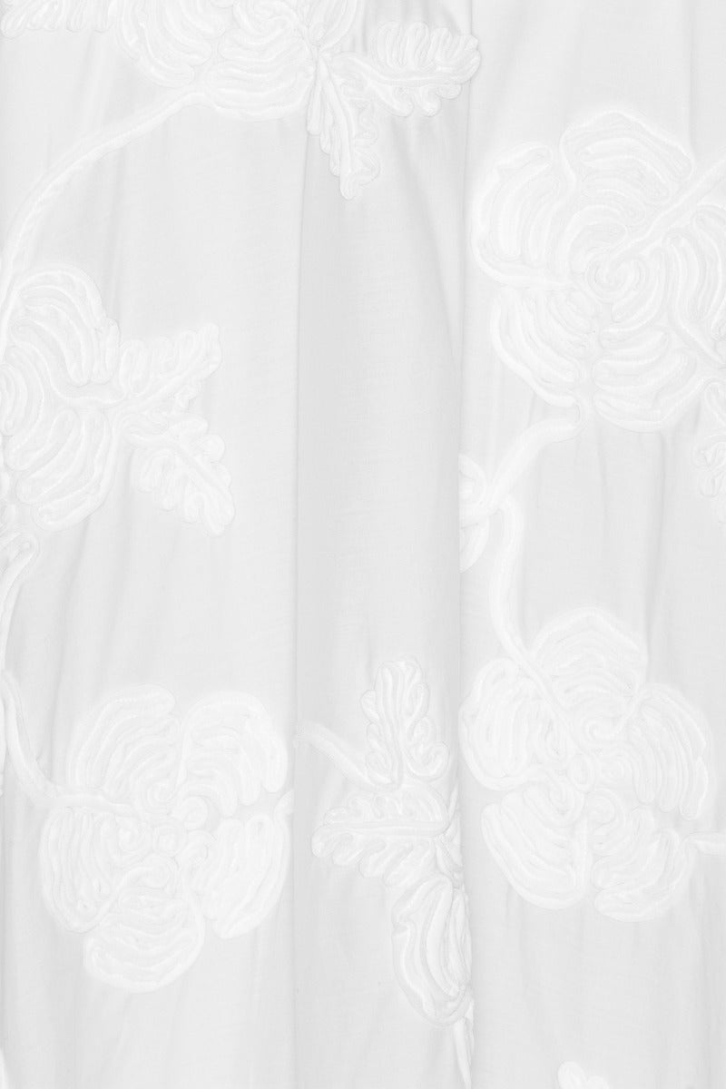 The Flower Maxi Skirt in Bright White combines elegance with comfort through its high-waisted design and voluminous flare, offering a flattering silhouette. Meticulously crafted with tonal floral embroidery, this skirt adds subtle sophistication to any outfit. Soft gathers at the waistband enhance its shape while a concealed side zipper ensures a seamless fit, making it a refined choice for both casual and formal occasions.