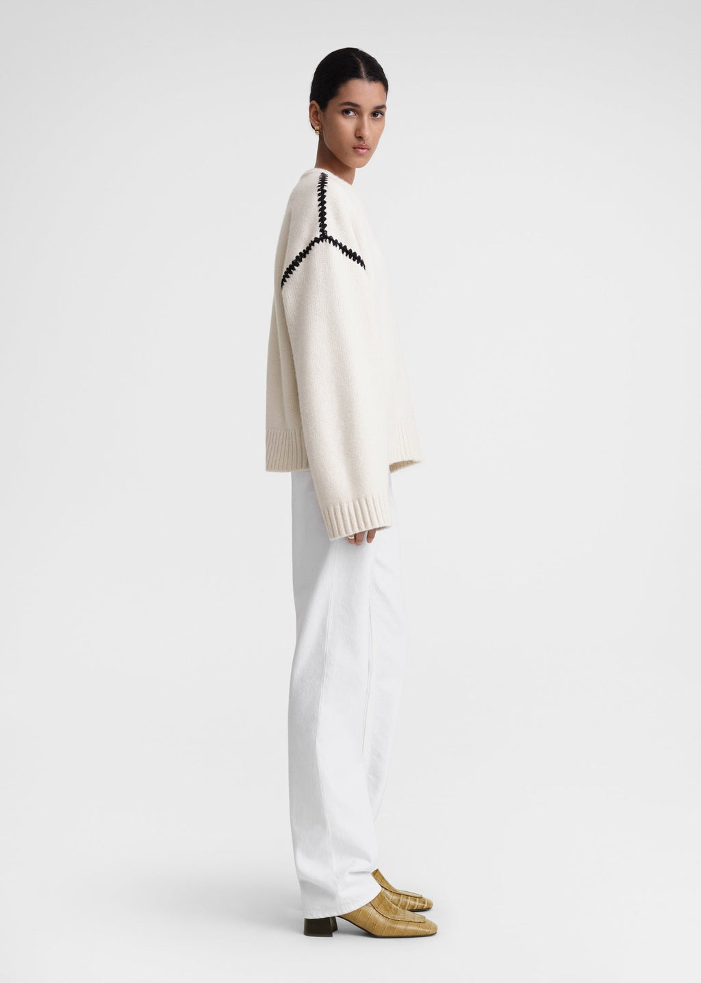 This wide sweater channels the refined aesthetic of TOTEME's Embroidered Scarf Jacket, crafted from mid-weight wool blended with cashmere for superior warmth and softness. Detailed with contrasting thread embroidery along the shoulders and armholes, it adds a sophisticated artisanal touch to classic knitwear. Pair it with the matching scarf to create a cohesive, statement winter ensemble that combines comfort with expert craftsmanship.