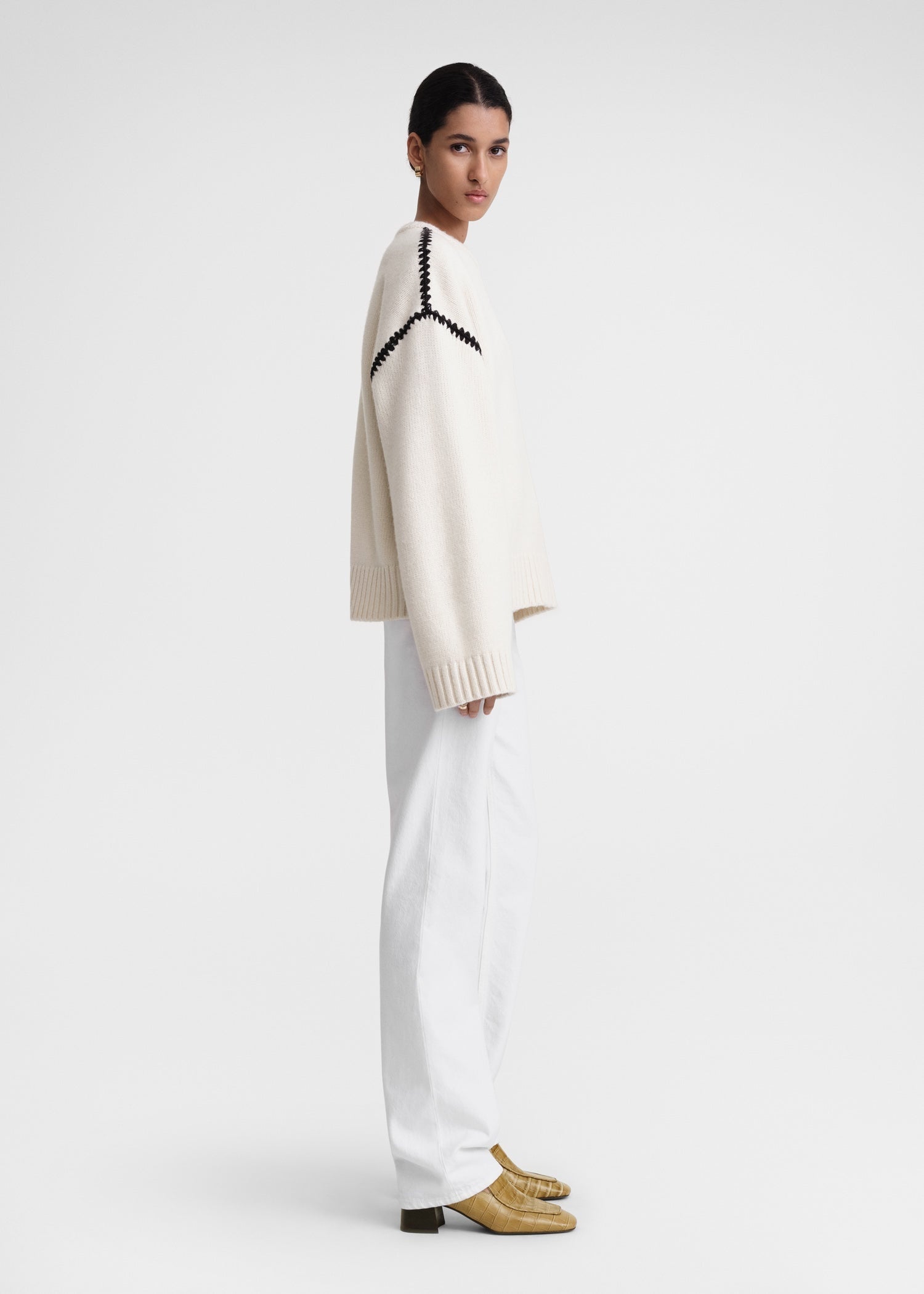 This wide sweater channels the refined aesthetic of TOTEME's Embroidered Scarf Jacket, crafted from mid-weight wool blended with cashmere for superior warmth and softness. Detailed with contrasting thread embroidery along the shoulders and armholes, it adds a sophisticated artisanal touch to classic knitwear. Pair it with the matching scarf to create a cohesive, statement winter ensemble that combines comfort with expert craftsmanship.