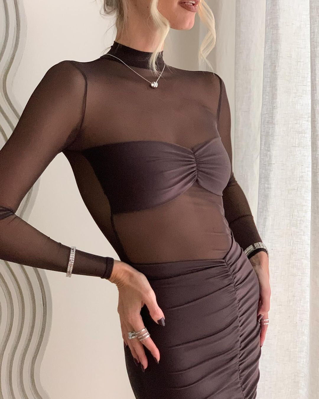 Elevate your style with the Levina Dress by SEROYA, a masterful blend of modern elegance and refined allure. This bodycon midi piece features a sheer bodice paired with a sleek bandeau detail, expertly tailored to accentuate your silhouette with subtle sophistication. Perfect for occasions demanding both poise and a touch of boldness, the Levina Dress in Ash Brown offers a striking yet understated statement.