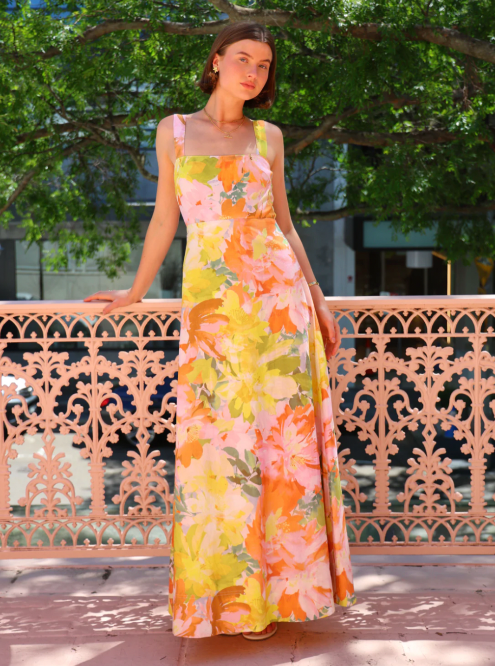 The Goldie Maxi Dress in Floral Confetti by Nicola offers a refined silhouette with a fully lined design and elegant circle skirt for graceful movement. Its wide straps and straight neckline highlight a flattering shape, while the delicate floral confetti pattern adds a soft, romantic touch. Finished with a discreet center-back zip, this dress ensures a seamless fit, making it an ideal choice for garden parties, weddings, or any event where effortless elegance is desired. 