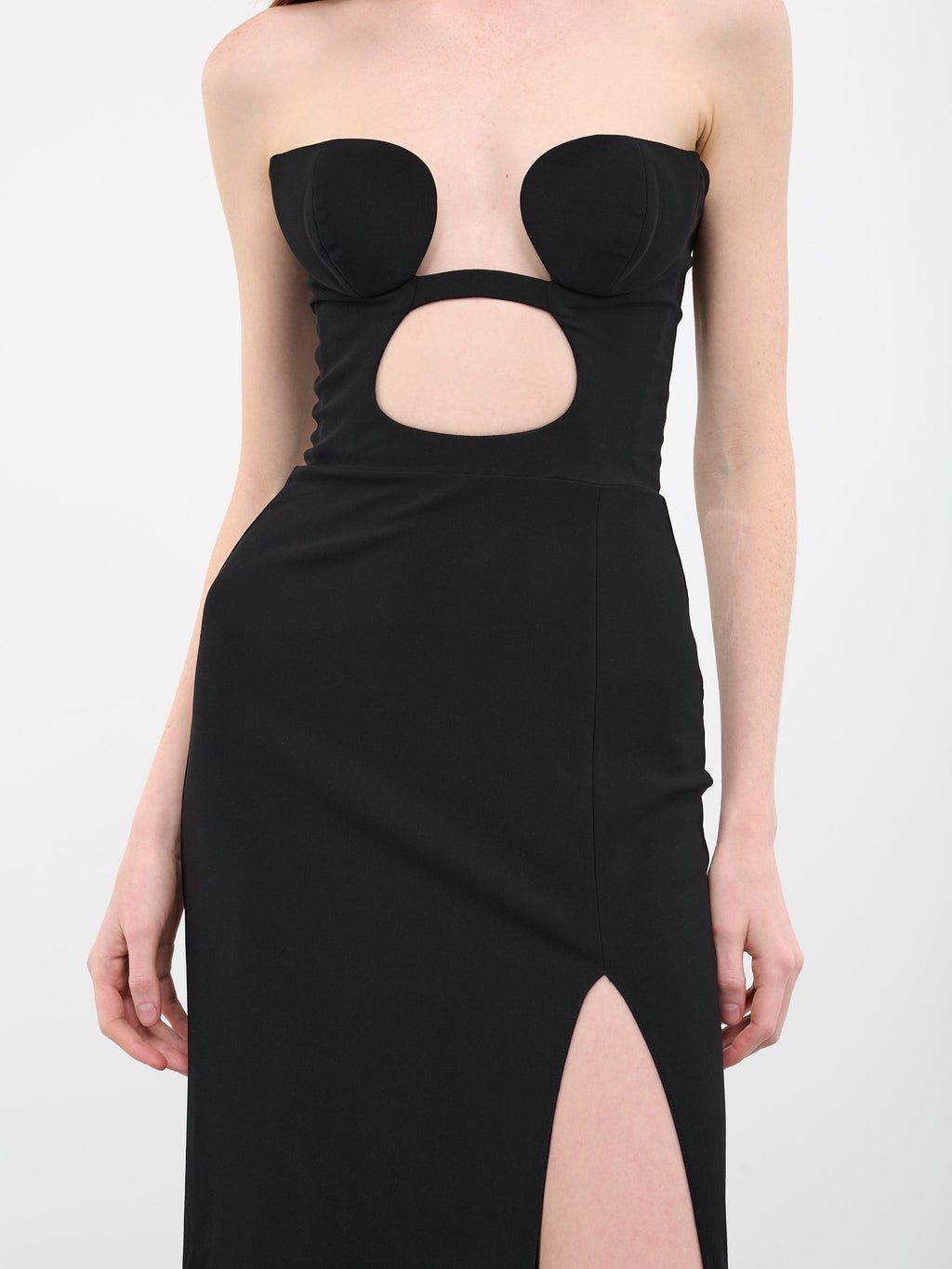 Nensi Dojaka's Volute Cut-out Dress in Jersey expertly balances bold design with flattering fit. Crafted from soft jersey and featuring a built-in padded bra, this dress provides seamless support while enhancing your silhouette. The striking front cut-out paired with a thigh-high slit creates an effortlessly dramatic look that commands attention without sacrificing comfort. Ideal for making a statement with refined ease.