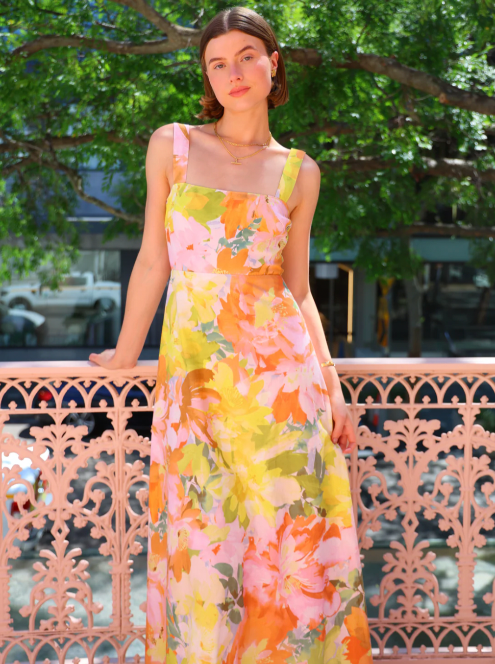 The Goldie Maxi Dress in Floral Confetti by Nicola offers a refined silhouette with a fully lined design and elegant circle skirt for graceful movement. Its wide straps and straight neckline highlight a flattering shape, while the delicate floral confetti pattern adds a soft, romantic touch. Finished with a discreet center-back zip, this dress ensures a seamless fit, making it an ideal choice for garden parties, weddings, or any event where effortless elegance is desired. 