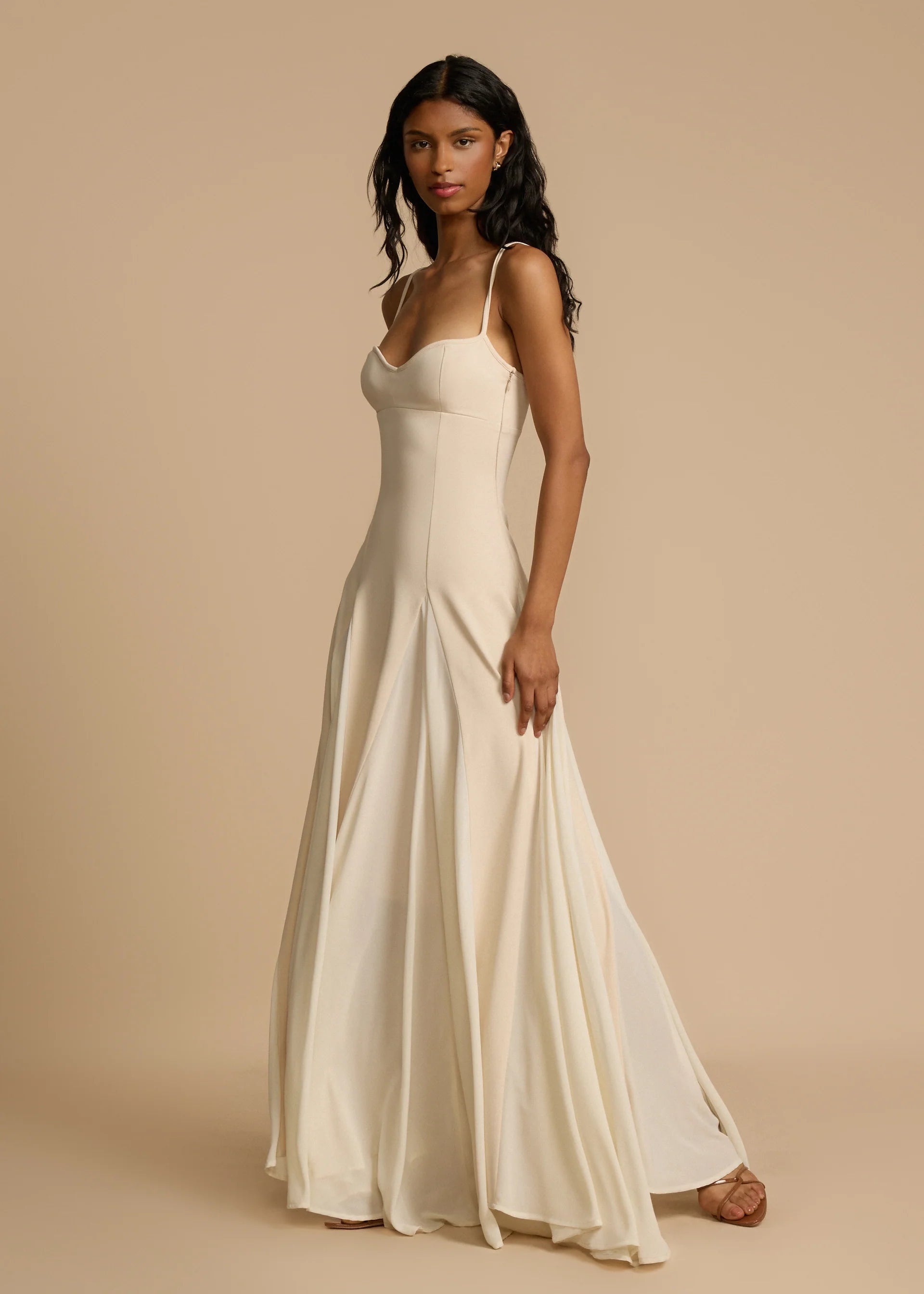 Paloma Dress by Arcina Ori combines classic elegance with modern design, featuring a paneled A-line skirt crafted from white georgette that drapes smoothly off the hips and moves gracefully. Its contrasting accents enhance fluidity, making it ideal for memorable occasions. Equipped with padded bra cups and binded edges, it offers structured support and a flattering silhouette. Paloma delivers refined sophistication and confidence from every perspective.