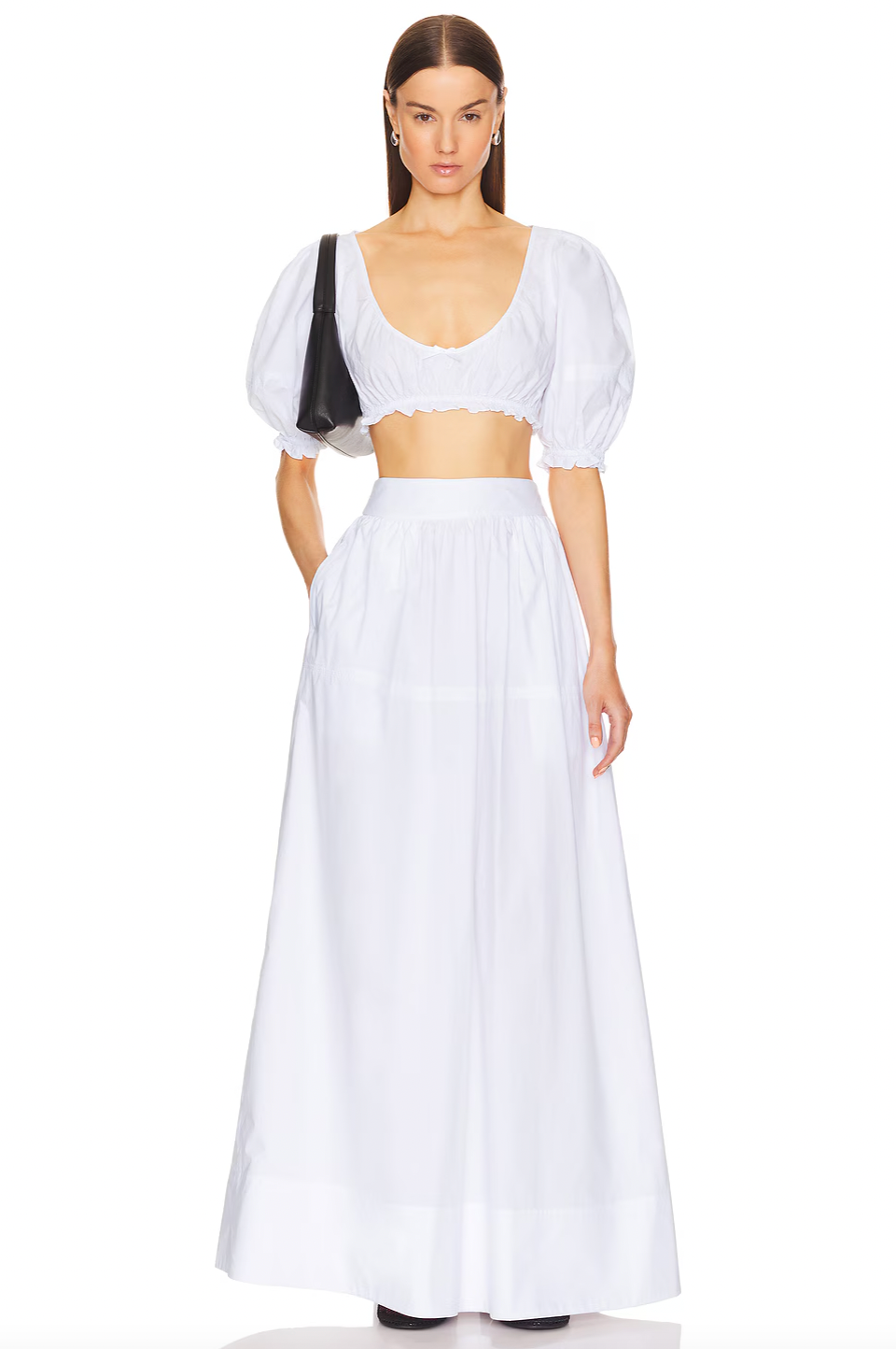 The Poplin Cropped Peasant Top by Helsa features airy puff sleeves with elastic cuffs for comfortable movement and a flattering silhouette. A delicate bow detail at the front adds a subtle touch of charm, while the elastic underband ensures a secure yet flexible fit. Crafted from lightweight poplin fabric, this top offers breathability and a crisp, polished appearance ideal for warm-weather styling.
