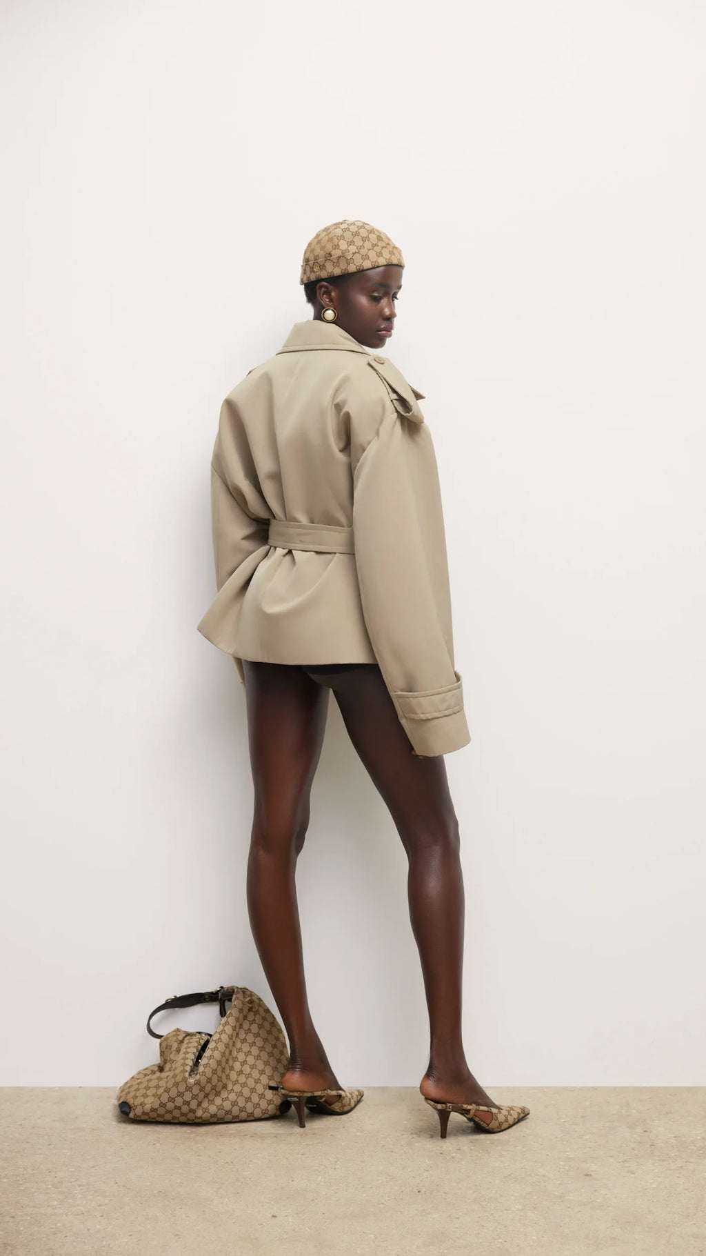 Elevate your wardrobe with this expertly tailored beige trench coat, offering a refined blend of classic design and contemporary appeal. The cropped silhouette enhances layering options, while the neutral beige shade ensures seamless coordination with varied outfits. Crafted for both comfort and style, this trench coat delivers a polished, sophisticated look that adapts effortlessly to different occasions. A versatile essential for a modern, elegant wardrobe.