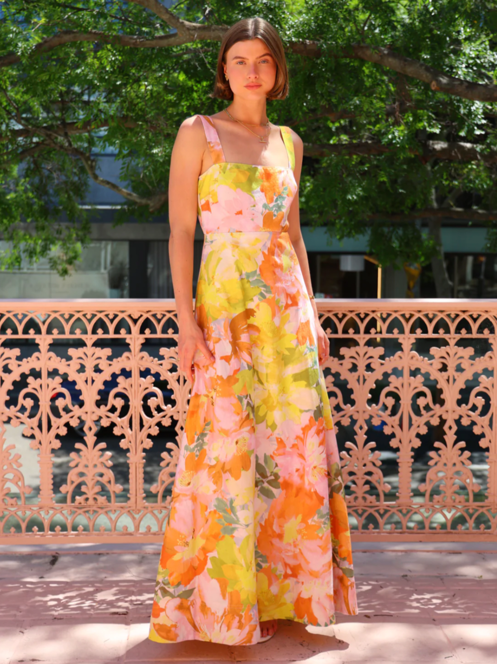 The Goldie Maxi Dress in Floral Confetti by Nicola offers a refined silhouette with a fully lined design and elegant circle skirt for graceful movement. Its wide straps and straight neckline highlight a flattering shape, while the delicate floral confetti pattern adds a soft, romantic touch. Finished with a discreet center-back zip, this dress ensures a seamless fit, making it an ideal choice for garden parties, weddings, or any event where effortless elegance is desired. 