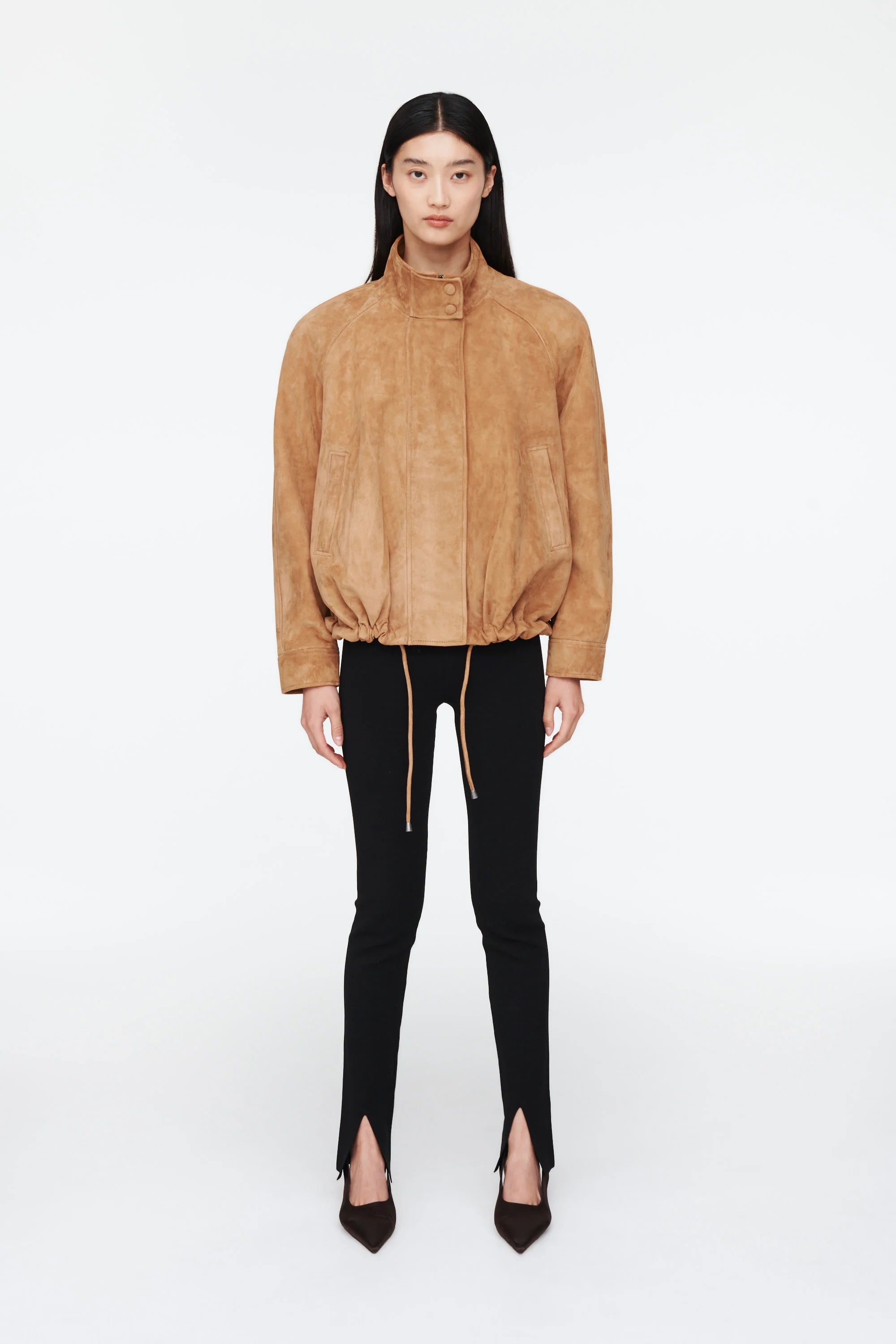 The Anastasia Suede Jacket by Ducie London offers a refined take on the classic aviator style, featuring a short stand collar that enhances its sleek profile. Its adjustable hem with drawstrings allows for a personalized fit, ensuring comfort and versatility. Crafted for enduring appeal, this jacket combines timeless design with functional details, making it a dependable choice for layering across seasons.