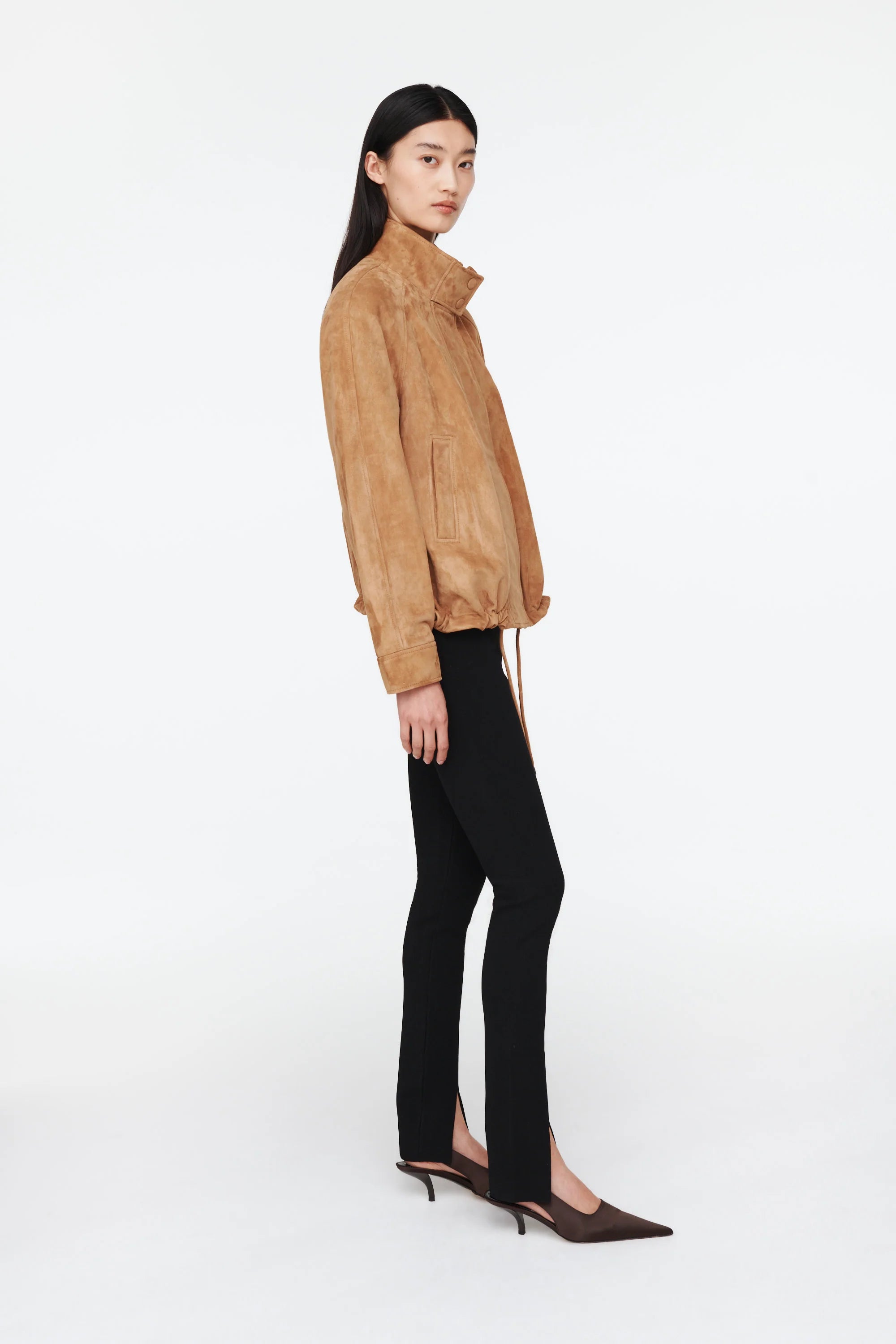 The Anastasia Suede Jacket by Ducie London offers a refined take on the classic aviator style, featuring a short stand collar that enhances its sleek profile. Its adjustable hem with drawstrings allows for a personalized fit, ensuring comfort and versatility. Crafted for enduring appeal, this jacket combines timeless design with functional details, making it a dependable choice for layering across seasons.