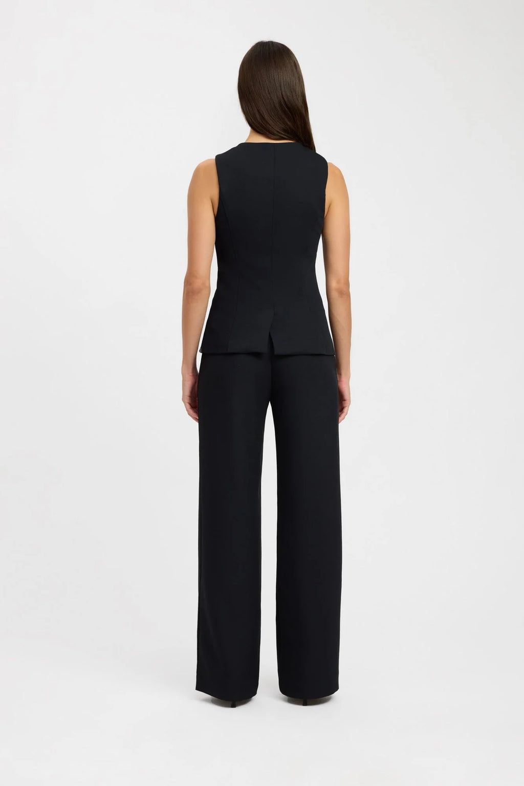 Elevate your fashion game with the Oyster Hook Crew Top in Black. Made from luxurious suiting fabric, this top boasts a sophisticated high neckline and flattering flared hemline. The adjustable gold hook and eye details add a touch of elegance and allow for customizable styling. Make a statement with this must-have piece.