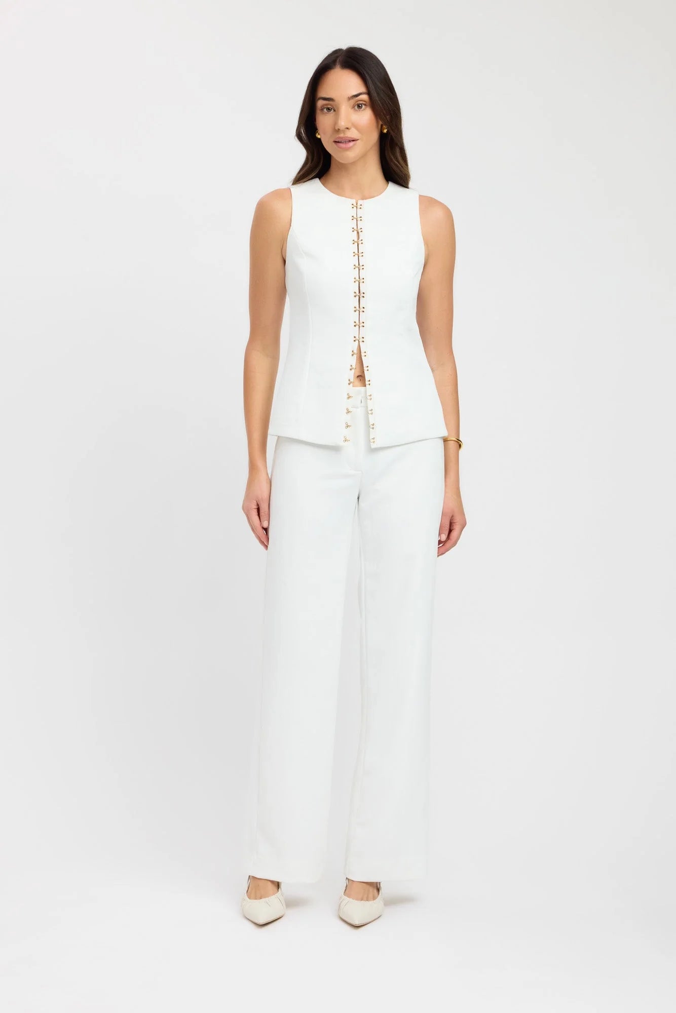 Introducing the Oyster Hook Crew Top, designed to make a statement. Crafted from suiting fabrication. The silhouette features an elegant high neckline and subtly flared hemline. Along with gold hook and eye details that can be adjusted for self styling.