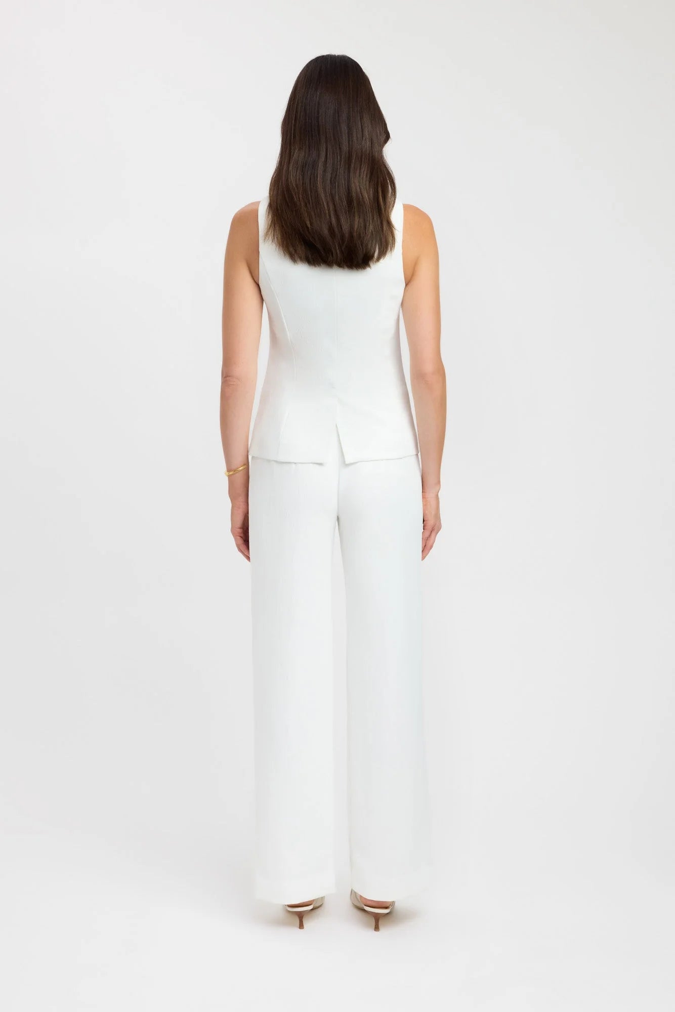 Introducing the Oyster Hook Crew Top, designed to make a statement. Crafted from suiting fabrication. The silhouette features an elegant high neckline and subtly flared hemline. Along with gold hook and eye details that can be adjusted for self styling.
