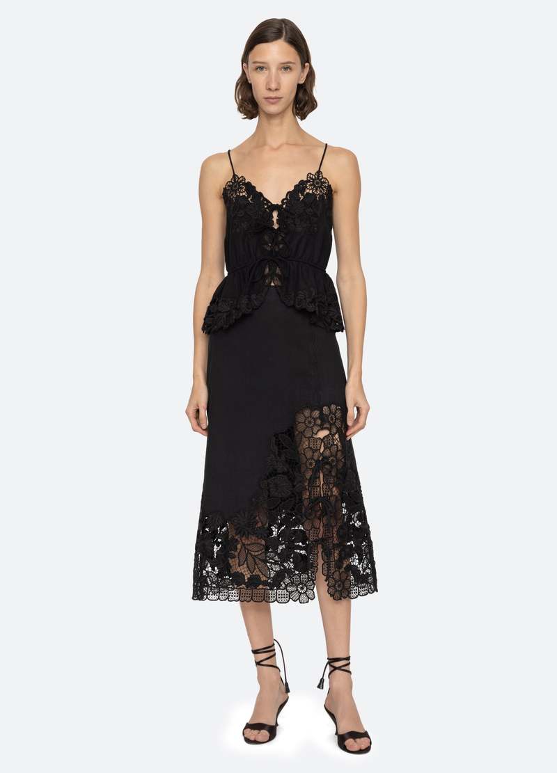 The Katharine Skirt showcases a sophisticated asymmetrical front slit complemented by delicate self ties, enhancing its elegant silhouette. Crafted with intricate floral lace and detailed embroidery, this skirt offers a refined texture and visual appeal. Designed to coordinate seamlessly with the Katharine embroidered slip top, it provides a polished, cohesive look ideal for elevated occasions.
