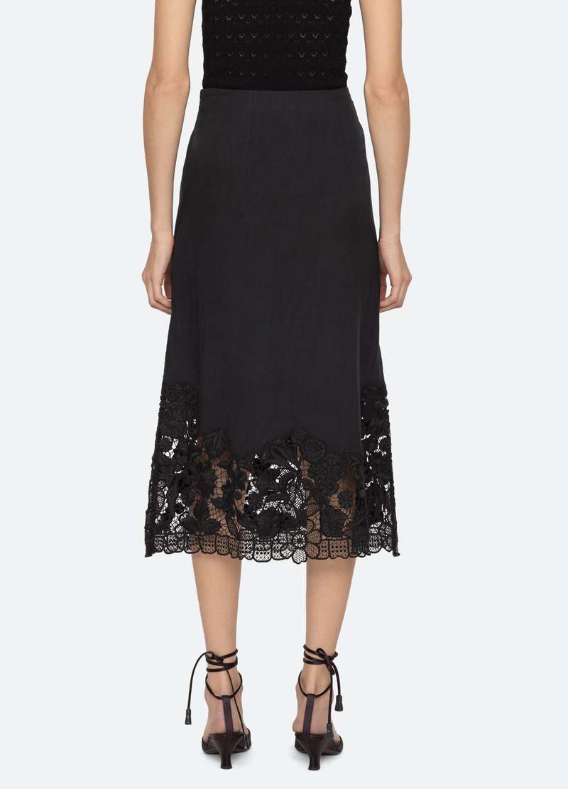 The Katharine Skirt showcases a sophisticated asymmetrical front slit complemented by delicate self ties, enhancing its elegant silhouette. Crafted with intricate floral lace and detailed embroidery, this skirt offers a refined texture and visual appeal. Designed to coordinate seamlessly with the Katharine embroidered slip top, it provides a polished, cohesive look ideal for elevated occasions.