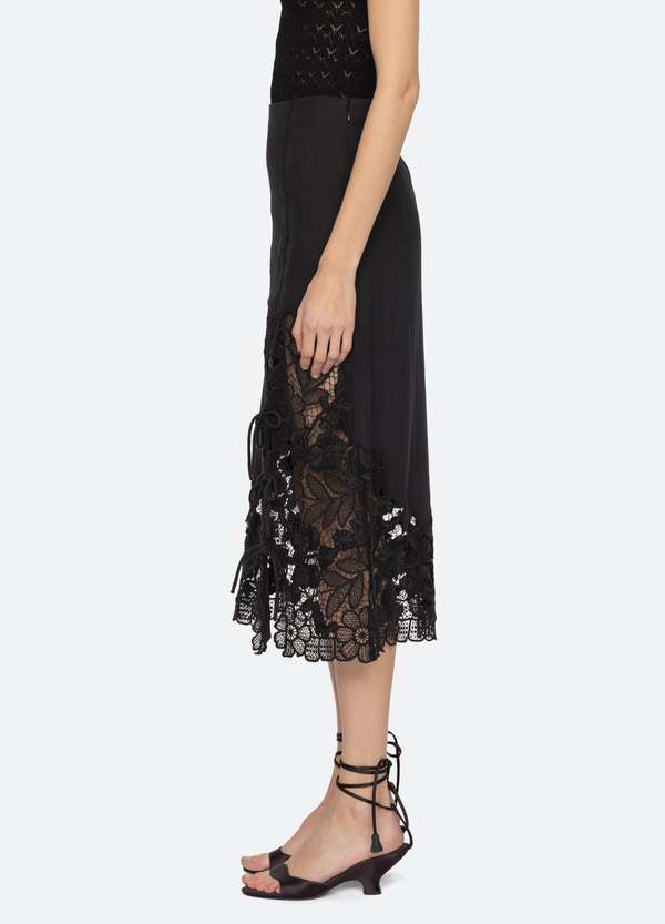 The Katharine Skirt showcases a sophisticated asymmetrical front slit complemented by delicate self ties, enhancing its elegant silhouette. Crafted with intricate floral lace and detailed embroidery, this skirt offers a refined texture and visual appeal. Designed to coordinate seamlessly with the Katharine embroidered slip top, it provides a polished, cohesive look ideal for elevated occasions.