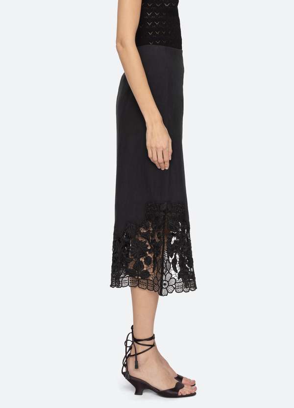 The Katharine Skirt showcases a sophisticated asymmetrical front slit complemented by delicate self ties, enhancing its elegant silhouette. Crafted with intricate floral lace and detailed embroidery, this skirt offers a refined texture and visual appeal. Designed to coordinate seamlessly with the Katharine embroidered slip top, it provides a polished, cohesive look ideal for elevated occasions.