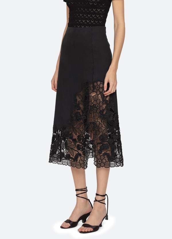 The Katharine Skirt showcases a sophisticated asymmetrical front slit complemented by delicate self ties, enhancing its elegant silhouette. Crafted with intricate floral lace and detailed embroidery, this skirt offers a refined texture and visual appeal. Designed to coordinate seamlessly with the Katharine embroidered slip top, it provides a polished, cohesive look ideal for elevated occasions.