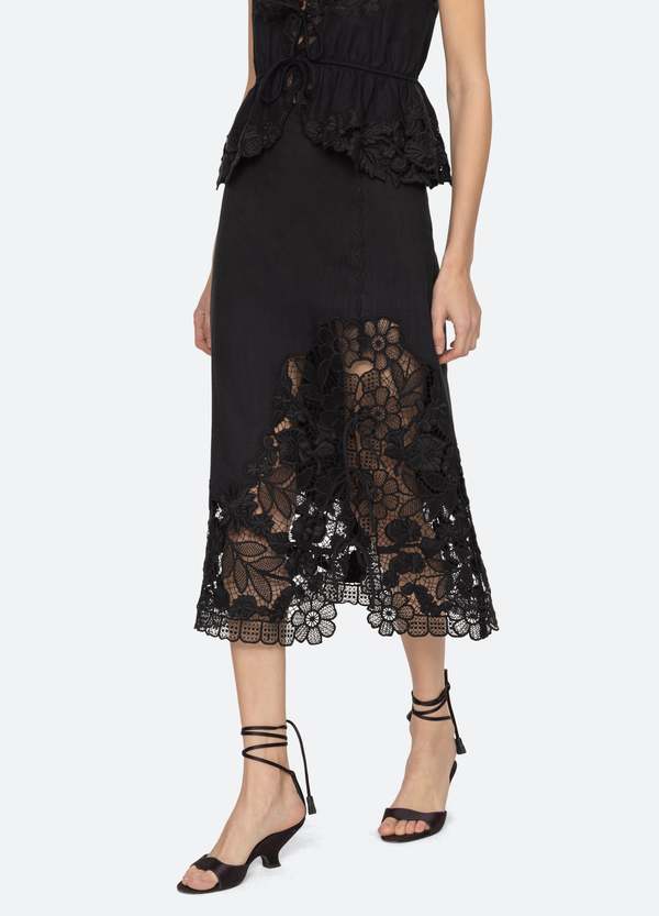 The Katharine Skirt showcases a sophisticated asymmetrical front slit complemented by delicate self ties, enhancing its elegant silhouette. Crafted with intricate floral lace and detailed embroidery, this skirt offers a refined texture and visual appeal. Designed to coordinate seamlessly with the Katharine embroidered slip top, it provides a polished, cohesive look ideal for elevated occasions.
