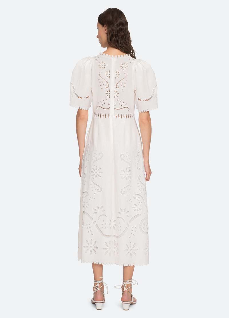 The Liat Dress by Sea New York combines delicate eyelet floral embroidery with thoughtful cutout accents and refined scalloped trim, offering a sophisticated touch to your wardrobe. Its short sleeves and intricate detailing create an elegant yet breathable design, perfect for warm weather occasions where effortless style and comfort are essential.