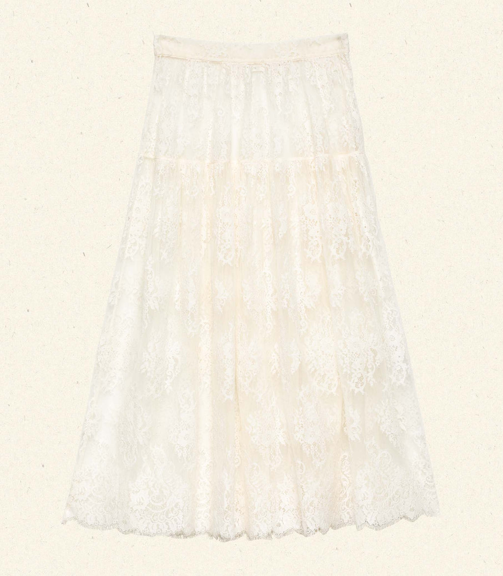 Crafted from delicate chantilly-inspired lace, the Sebastiane Skirt by Doen embodies timeless romance with its flattering A-line silhouette. The high waist creates an elegant line while the scalloped hem adds refined detail as it gracefully reaches mid-shin. Unlined for a lightweight feel, this piece pairs beautifully with a slip for your preferred level of coverage. A sophisticated choice for occasions calling for understated femininity.