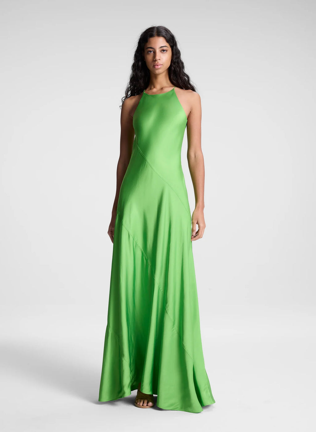 The Sybil Satin Maxi Dress by A.L.C showcases the refined elegance of fluid viscose satin in a striking lime green. Its bias-cut construction creates a graceful, body-skimming silhouette that moves with you, while the high halter neckline and delicate straps deliver a sculpted, sophisticated look. Perfect for elevated occasions where understated luxury speaks volumes.