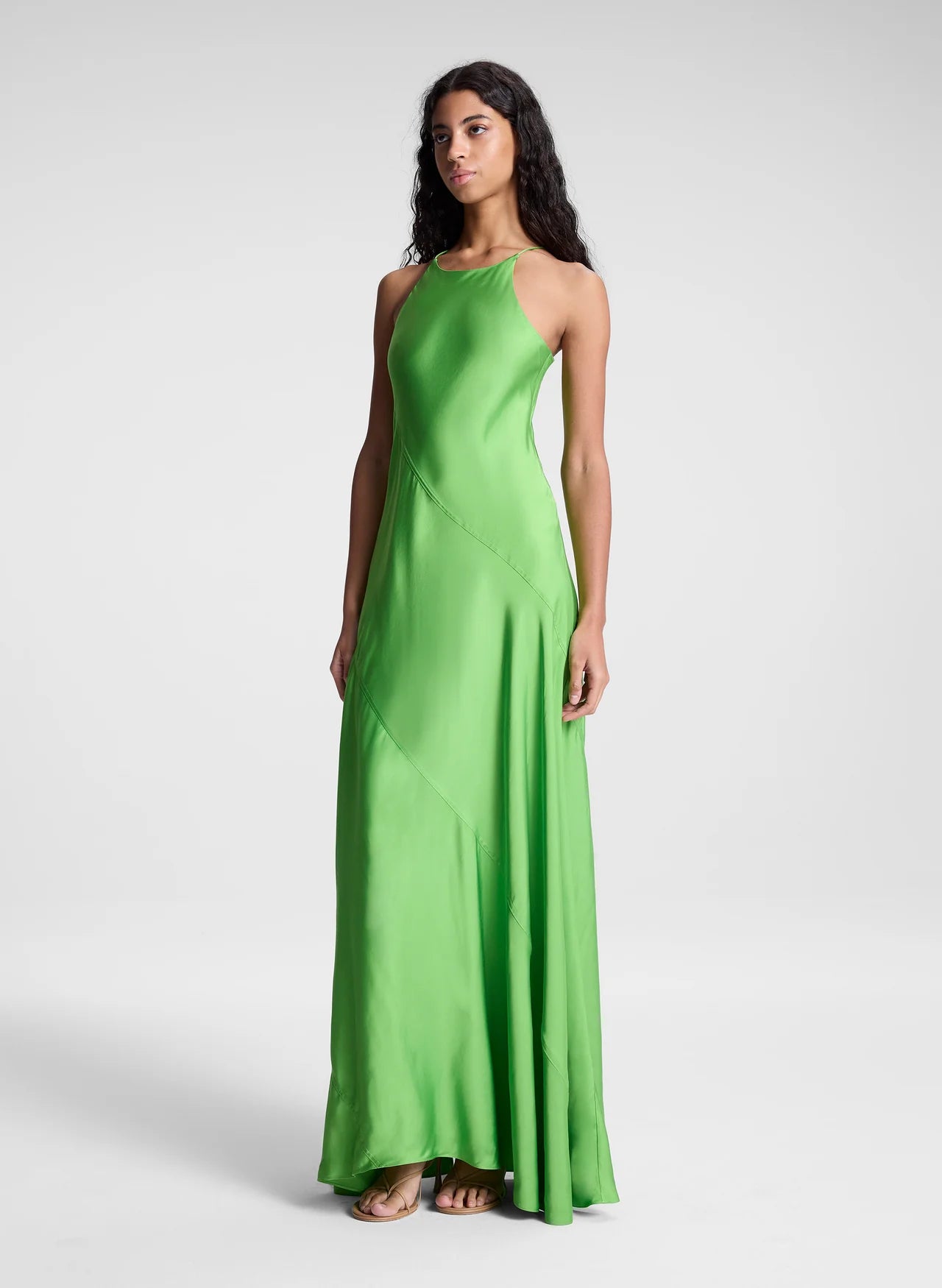 The Sybil Satin Maxi Dress by A.L.C showcases the refined elegance of fluid viscose satin in a striking lime green. Its bias-cut construction creates a graceful, body-skimming silhouette that moves with you, while the high halter neckline and delicate straps deliver a sculpted, sophisticated look. Perfect for elevated occasions where understated luxury speaks volumes.