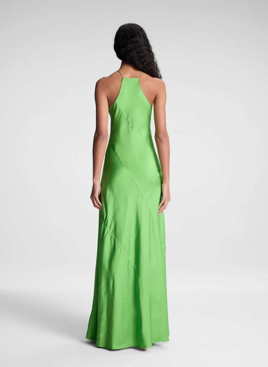 The Sybil Satin Maxi Dress by A.L.C showcases the refined elegance of fluid viscose satin in a striking lime green. Its bias-cut construction creates a graceful, body-skimming silhouette that moves with you, while the high halter neckline and delicate straps deliver a sculpted, sophisticated look. Perfect for elevated occasions where understated luxury speaks volumes.