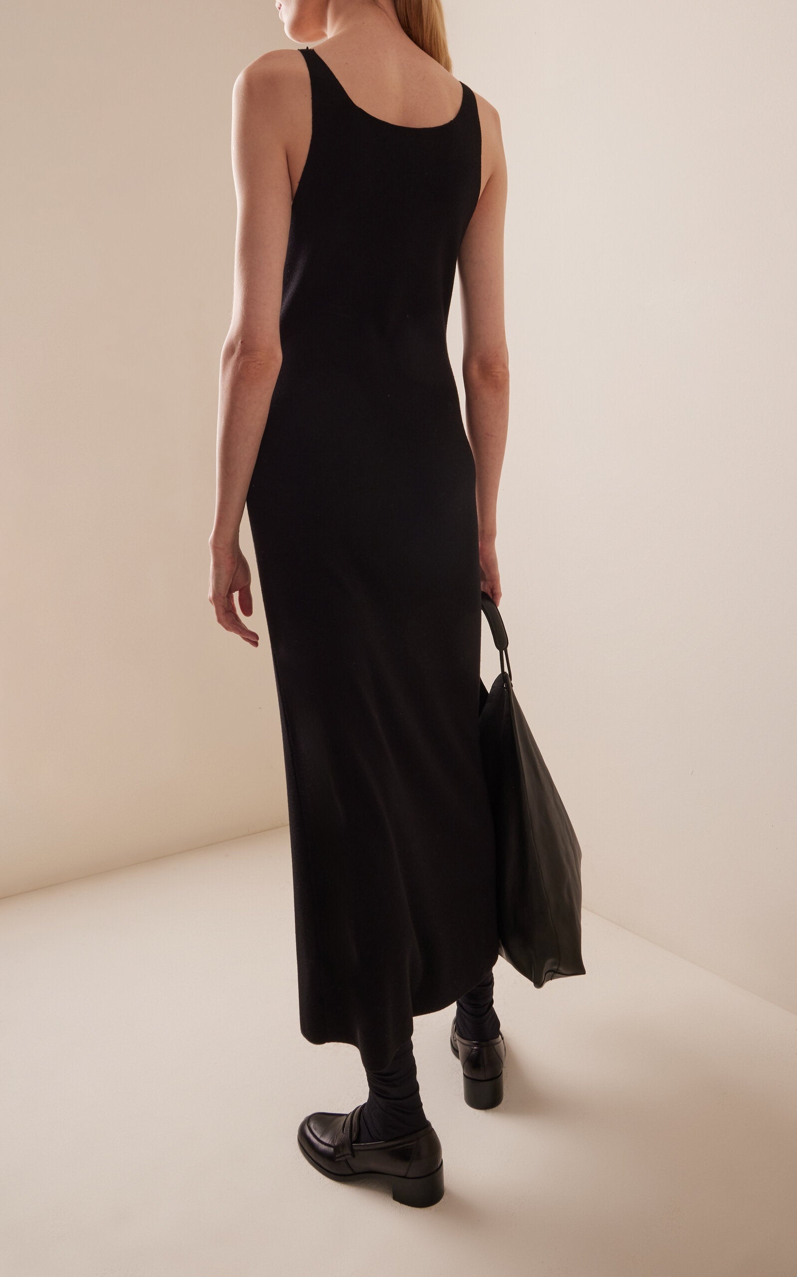 Crafted from fine technical wool, the Florio Dress in Stretch Wool by The Row offers a tailored fit that gently contours the body. Its ankle-length silhouette and thin straps create a refined, modern look, while the wide neckline adds subtle elegance. Ideal for sophisticated occasions, this dress combines comfort and style with the breathable, flexible qualities of stretch wool.