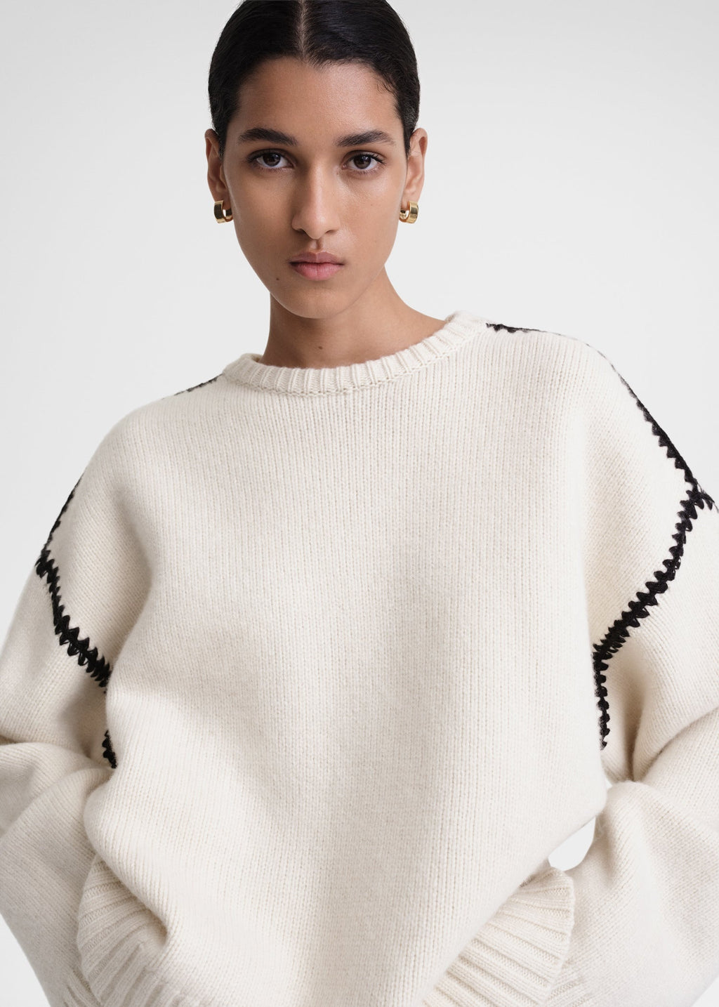 This wide sweater channels the refined aesthetic of TOTEME's Embroidered Scarf Jacket, crafted from mid-weight wool blended with cashmere for superior warmth and softness. Detailed with contrasting thread embroidery along the shoulders and armholes, it adds a sophisticated artisanal touch to classic knitwear. Pair it with the matching scarf to create a cohesive, statement winter ensemble that combines comfort with expert craftsmanship.