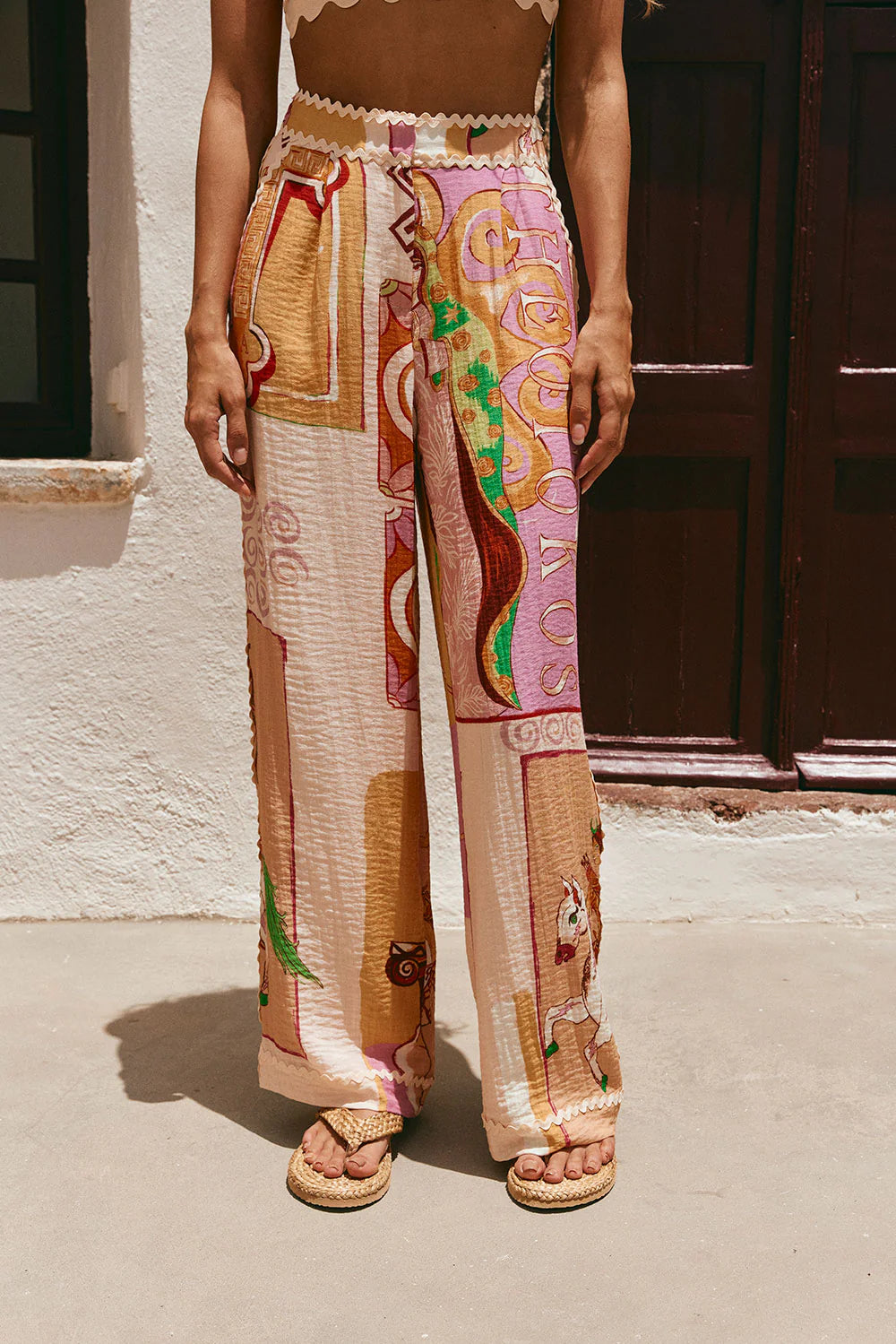 These Kelia Pants in Theotokos Peach by SABO offer a versatile blend pant with a high waist and ric rac trim detailing. With twin pockets and a wide fit, these pants provide both style and functionality. Perfect for any occasion, these pants are a must-have for your wardrobe.