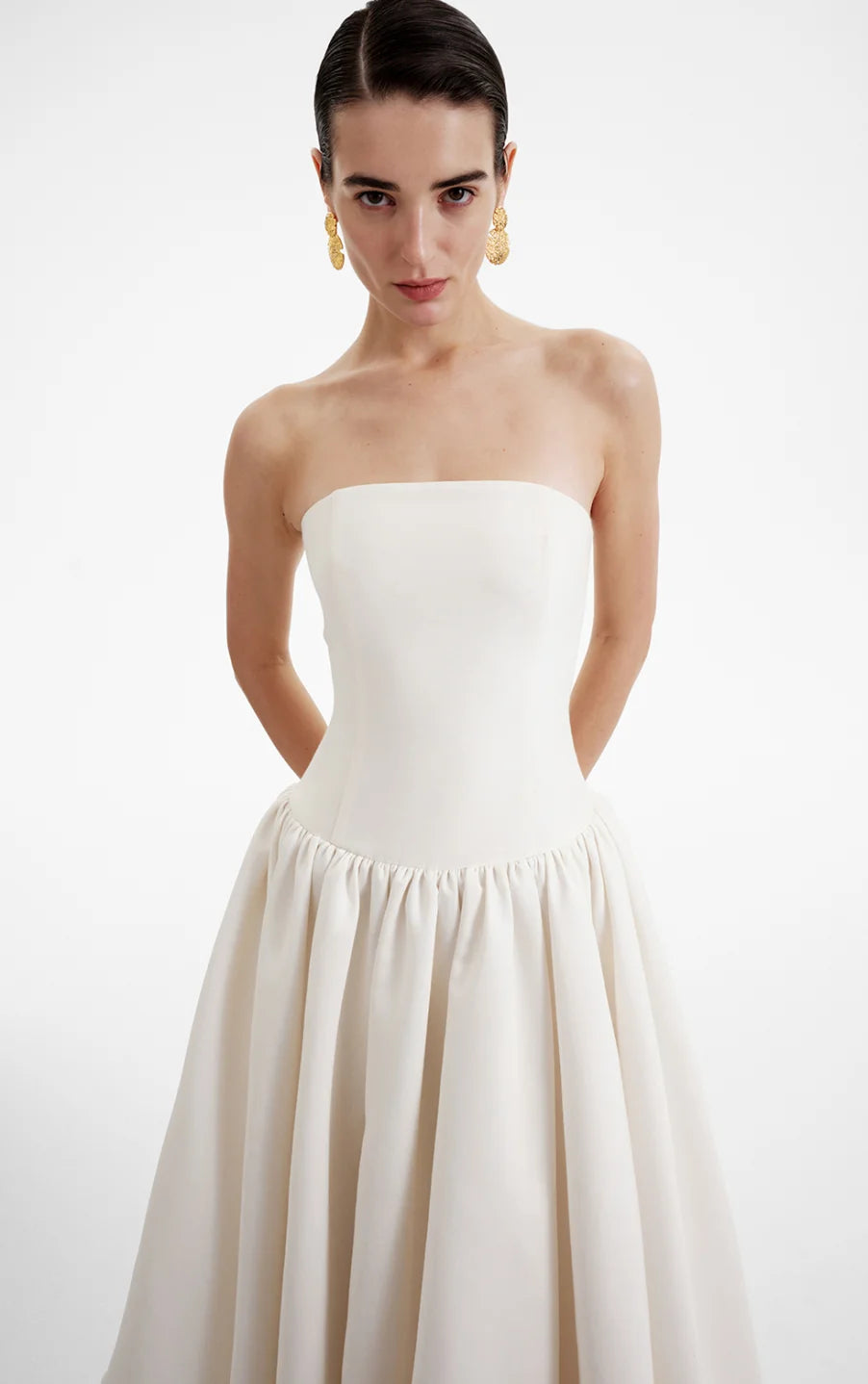 The Opera Gown combines classic elegance with contemporary design, featuring a strapless solid bodice and a high-waisted, pleated A-line skirt that flatters the figure. Its sleeveless construction offers both comfort and style, making it an excellent choice for summer occasions and formal events. This gown seamlessly blends sophistication with ease, providing a refined yet effortless look for warm-weather gatherings.