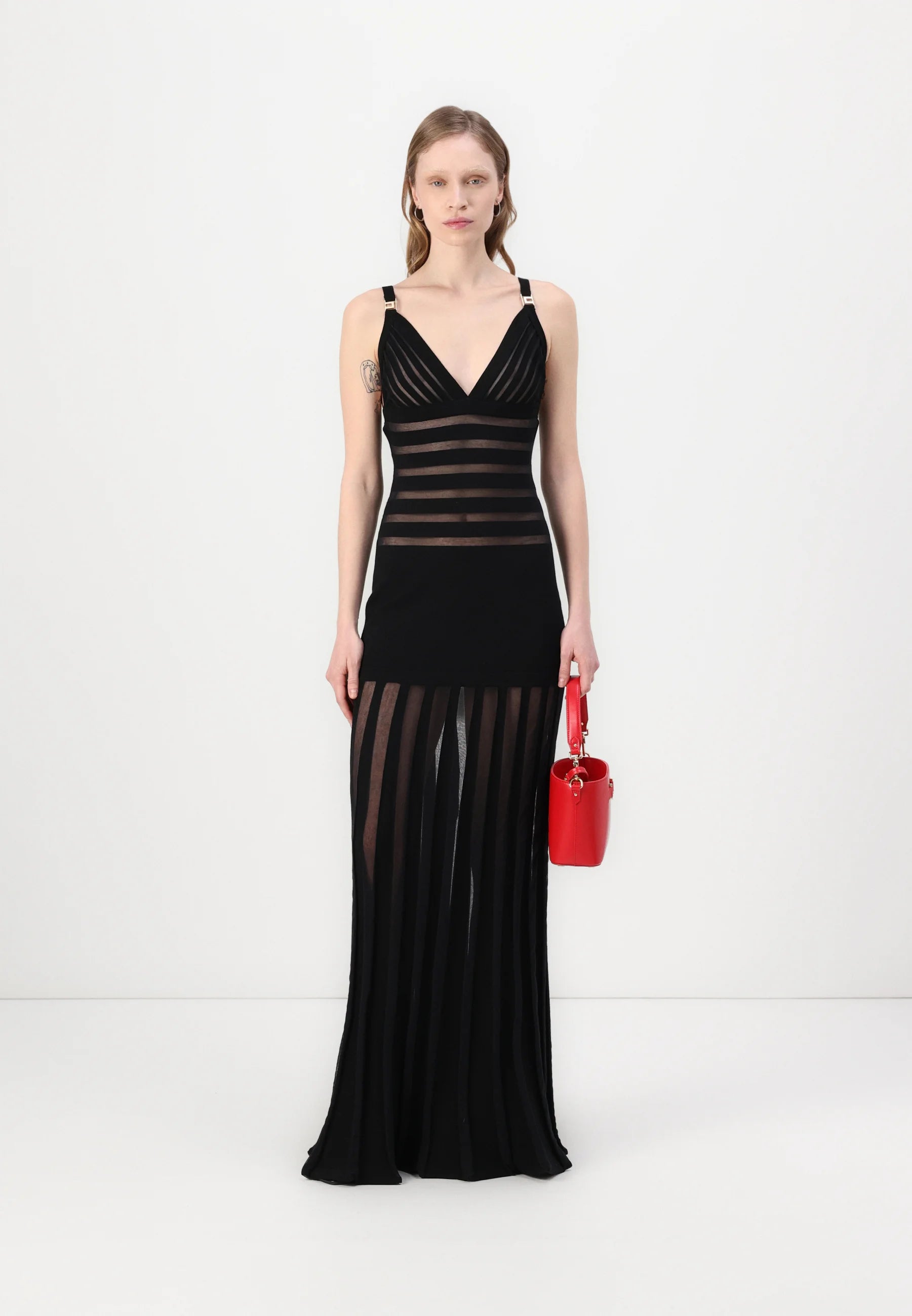 This Elisabetta Franchi maxi dress combines sophisticated knit fabric with elegant transparency details, creating a refined silhouette that balances coverage and allure. Expertly crafted, it offers a flattering fit ideal for formal occasions or evening events where style and comfort are paramount.