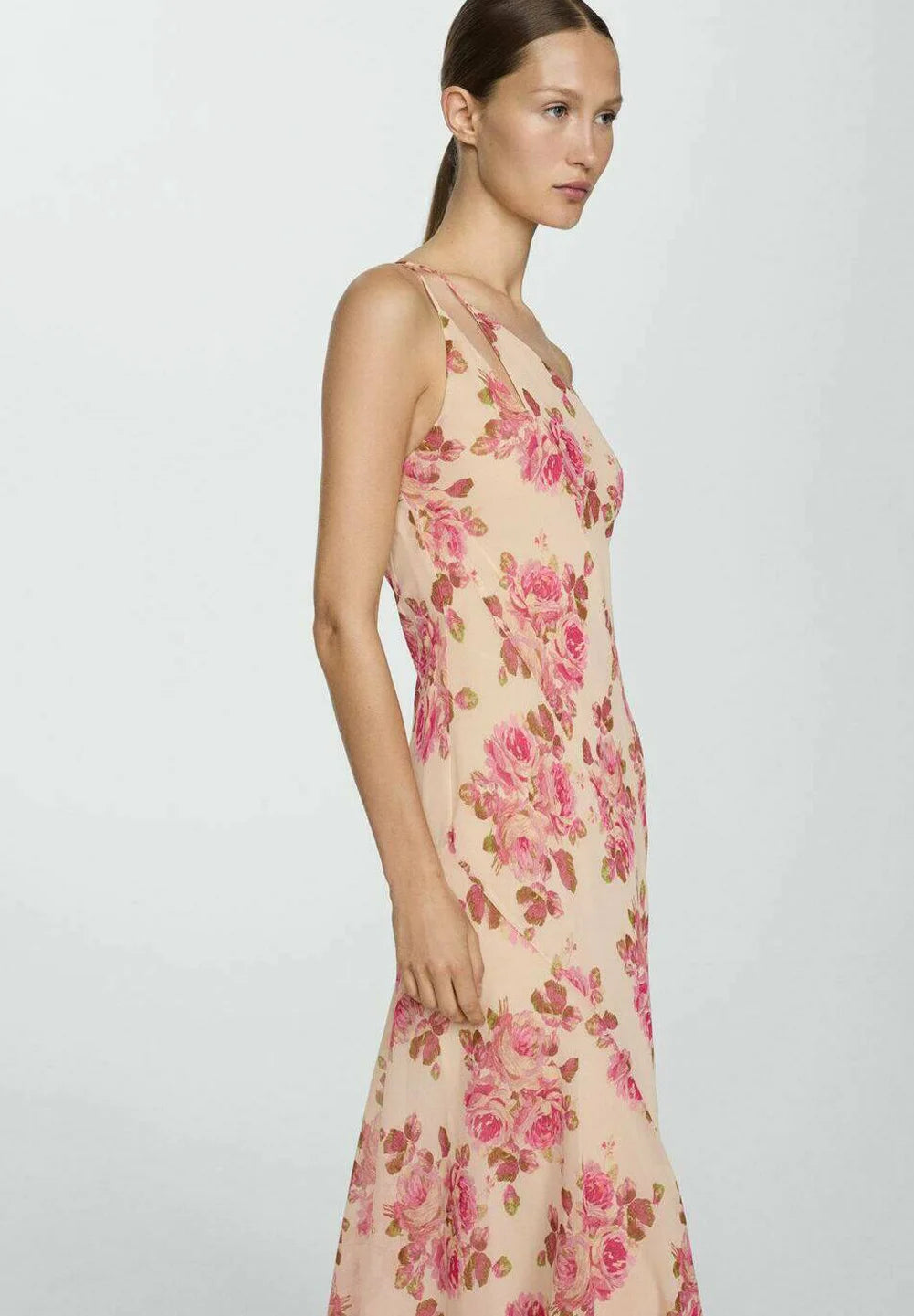 The Floral Slip Maxi Dress offers an elegant silhouette with its flowing maxi length and delicate floral pattern. Crafted for comfort and style, this dress features thin straps and a slip design that drapes gracefully over the body. Ideal for warm weather or layered in cooler seasons, it combines versatility with a timeless aesthetic perfect for both casual outings and special occasions.