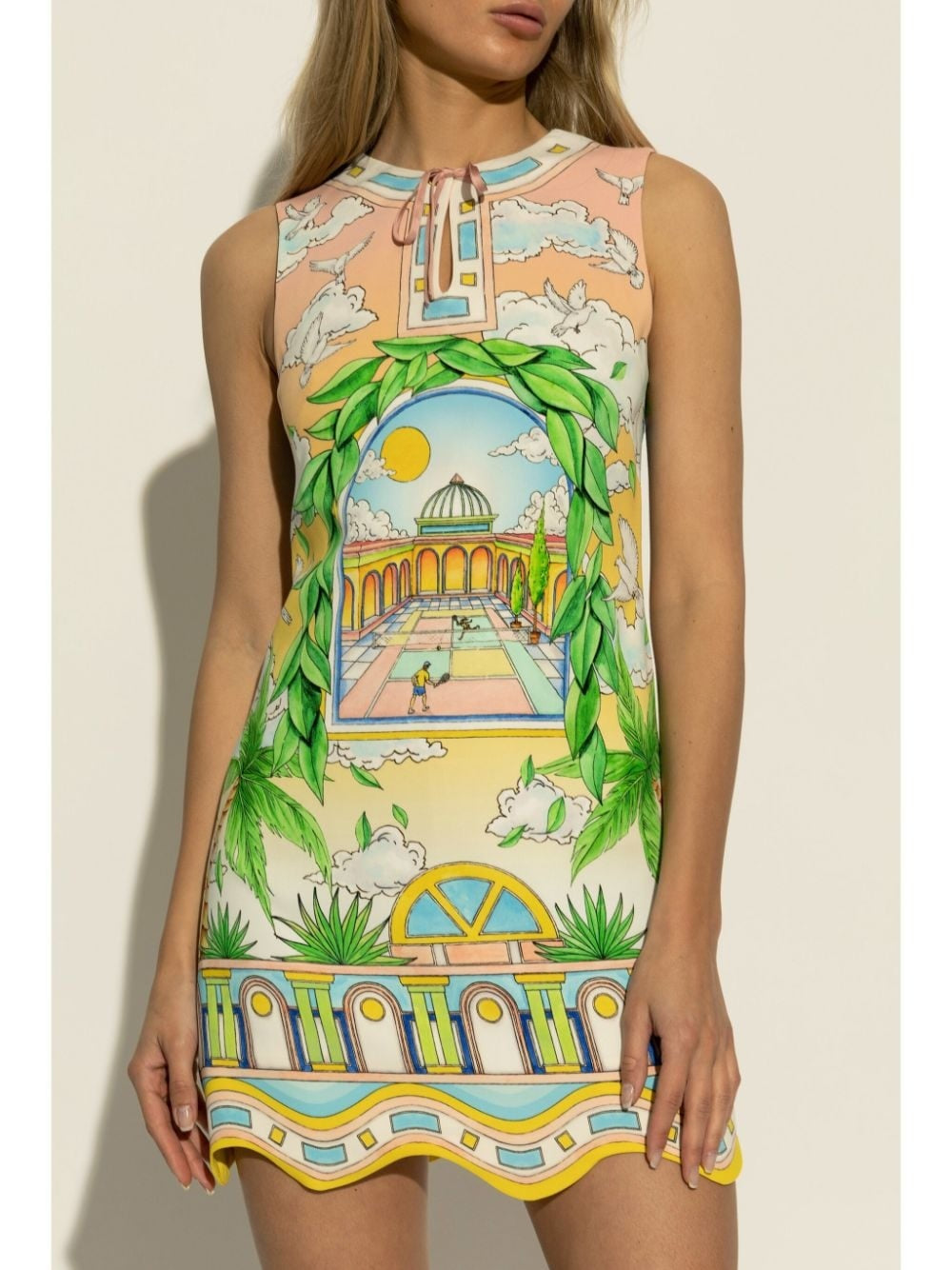 Elevate your wardrobe with the Paysage Ideal graphic-print minidress by Casablanca, expertly crafted in Italy. Featuring a vibrant grass green and multicolour all-over graphic print, this thigh-length dress showcases an A-line silhouette with a delicate scallop hem. The sleeveless design is complemented by a keyhole neck and front tie fastening, while a concealed rear zip ensures a seamless fit. 