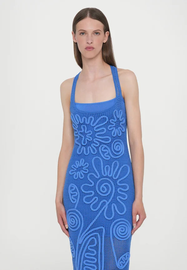 Elevate your wardrobe with the Nissa Dress in Capri by Cult Gaia, featuring a sophisticated sleeveless midi silhouette. Crafted with a delicate netting body, it is beautifully adorned with a detailed floral cord overlay for a refined texture and visual interest. Fully lined with a mini slip, this dress ensures comfortable coverage and ease of wear. Its effortless pull-on design offers convenience without compromising style, making it an ideal choice for elegant day or evening occasions.