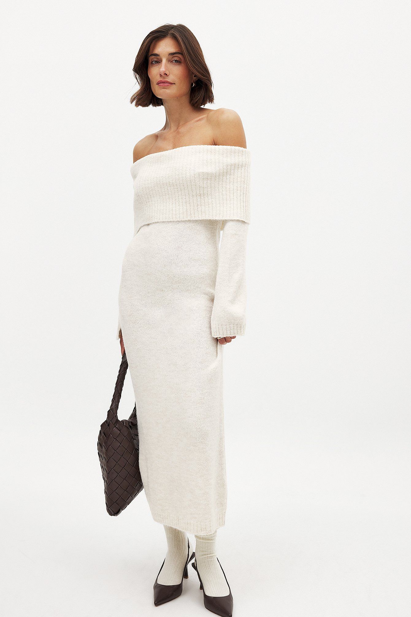 This knitted midi dress combines comfort and style with its relaxed fit and stretchy knit fabric, ensuring ease of movement throughout the day. The folded off-shoulder design adds a touch of elegance, while the long sleeves feature a subtle slit detail for an understated, modern edge. Ideal for sophisticated casual outings, this dress balances effortless wearability with refined fashion details.