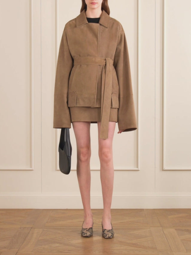 A sophisticated layer from KHAITE, the Alder jacket showcases premium suede in a refined, cropped cut. Its supple texture delivers a luxurious sheen, while the sharp collar and minimal detailing create a modern silhouette. Structured yet fluid, this pared-back essential strikes the perfect balance between polish and ease—a versatile piece that elevates any wardrobe.