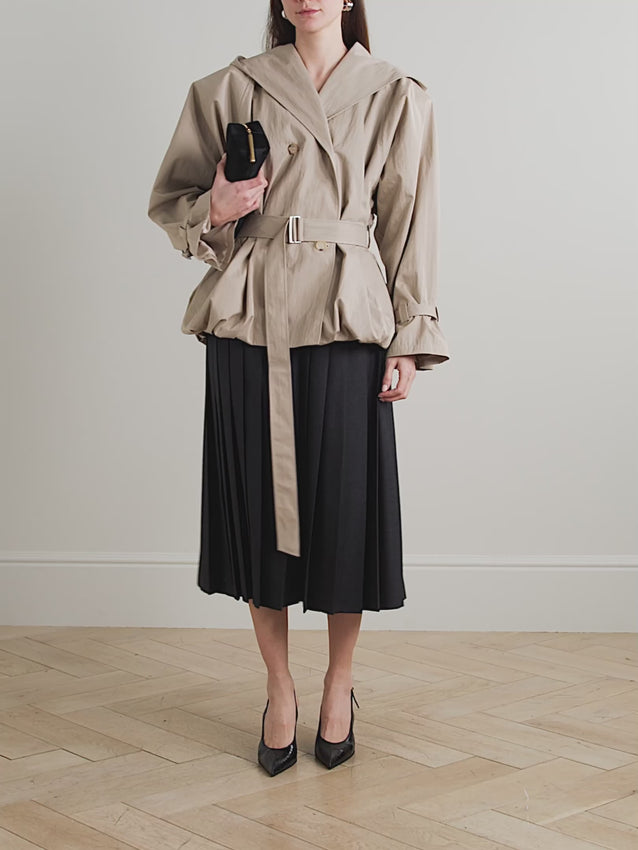 Crafted from a luxurious cotton-blend fabric, this hooded belted jacket combines contemporary style with practical elegance. The adjustable hood provides versatile coverage, while the structured belt cinches the waist for a refined silhouette. Perfect for layering through transitional seasons, this piece transitions seamlessly from casual to polished looks. The quality construction ensures lasting wear and comfort.