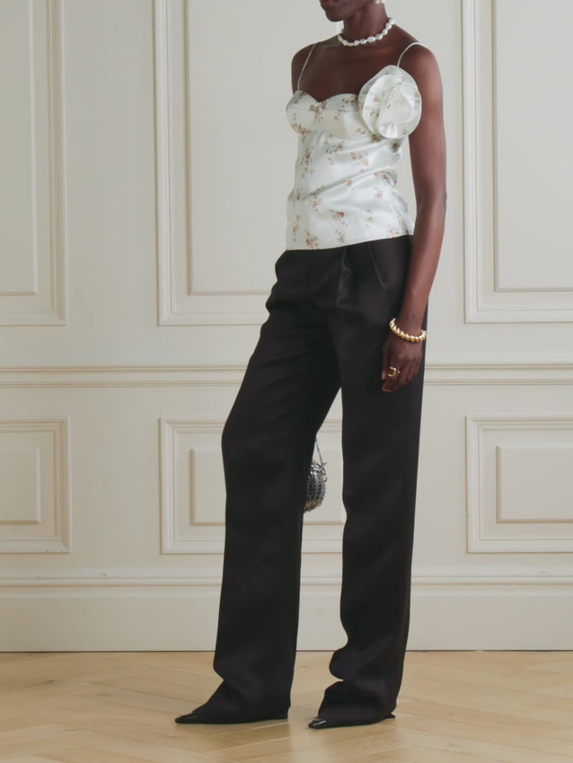 Elevate your wardrobe with this exquisite silk bustier top by Magda Butrym. Crafted from luxurious silk fabric, this piece features delicate appliquéd floral-print detailing that adds sophisticated charm and visual interest. The structured bustier silhouette provides flattering support and a refined, polished look perfect for both special occasions and elevated everyday wear. The intricate floral embellishments showcase meticulous craftsmanship, making this top a standout statement piece. 