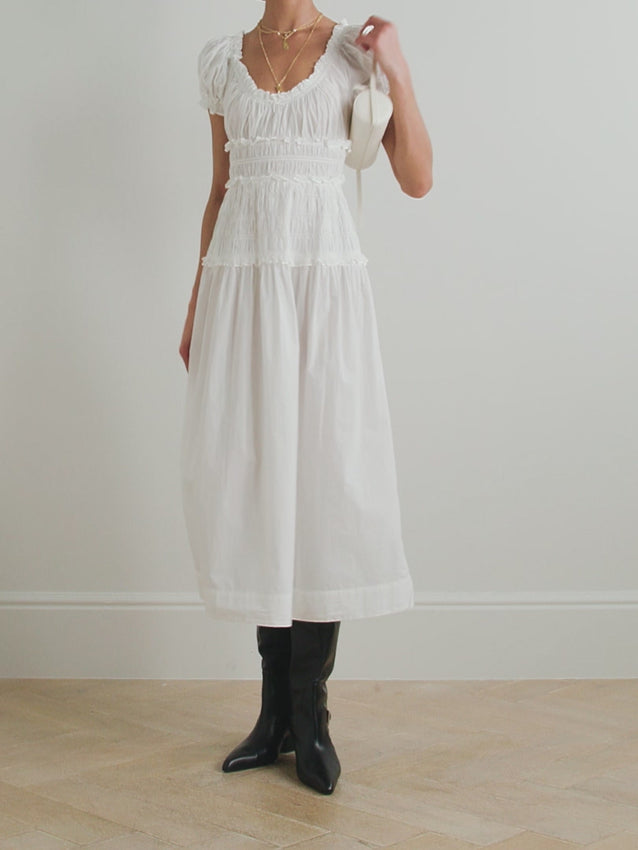Embrace effortless romance with the Leanne midi dress, crafted from breathable cotton-voile that moves with you. Designed with charming puffed sleeves and a flexible shirred waistband, this piece offers comfort without compromise. The relaxed silhouette is perfect for warm days and pairs beautifully with pastel accessories for a soft, romantic aesthetic. A versatile staple that captures signature blend of fun and wearability.
