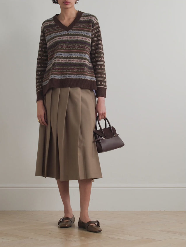 This versatile sweater combines classic style with modern comfort. The mid-weight fair isle knit features a subtle stretch for ease of movement, while the contrasting striped cotton-poplin back panel adds visual interest. A flattering V-neckline, long sleeves with ribbed trim, and a partial elastic waistband create a polished silhouette that works for any occasion.