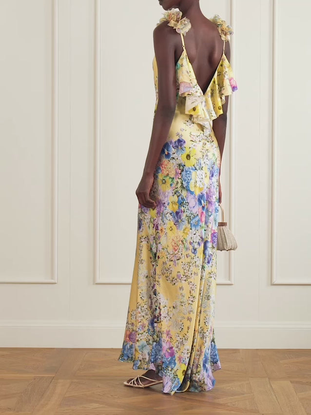 Inspired by the vibrant blooms of Turkish markets, the Darling Buds print adorns this luxurious silk-satin maxi dress. Cut on the bias for an elegant drape, it features dimensional 3D flower appliqués at the straps and playful ruffles tracing the low-cut back. Delicate crystal embellishments add a touch of refined sparkle, making this piece perfect for special occasions where you want to make a memorable impression.
