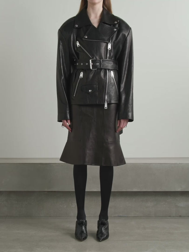 The Fabbie biker jacket reimagines a timeless silhouette through meticulous attention to proportion and fit. Crafted from supple leather, it features dramatically padded shoulders that command presence with architectural dimension. Silver-tone hardware elevates the design—from zipped cuffs to a buckle-fastening belt that defines the waist. A modern take on a classic, this jacket balances edge with refined elegance.