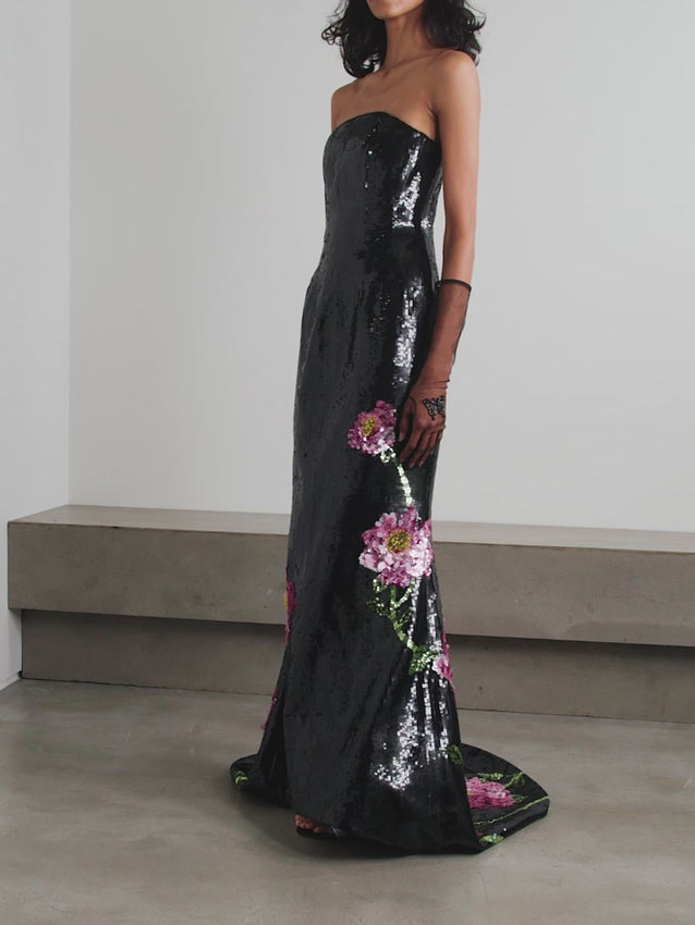 Elevate your evening with the Peony strapless gown by Clio Peppiatt, a masterpiece of refined elegance. This stunning design features a sweetheart neckline and graceful strapless silhouette, adorned with intricate sequin embellishments that catch the light with every movement. The luxurious tulle construction creates a ethereal, romantic aesthetic perfect for galas, weddings, and formal celebrations. 