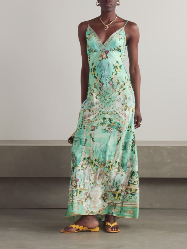 Designed in collaboration with the award-winning show The White Lotus, this stunning maxi dress features a gorgeous Italian Renaissance illustration with gilded archways, lush flowers, and lemons. Crafted from silk and cut on the bias, it skims your figure beautifully while the plunging crystal-embellished neckline is mirrored by a low-cut back for an elegant, dramatic silhouette. A timeless piece that captures luxury and sophistication.