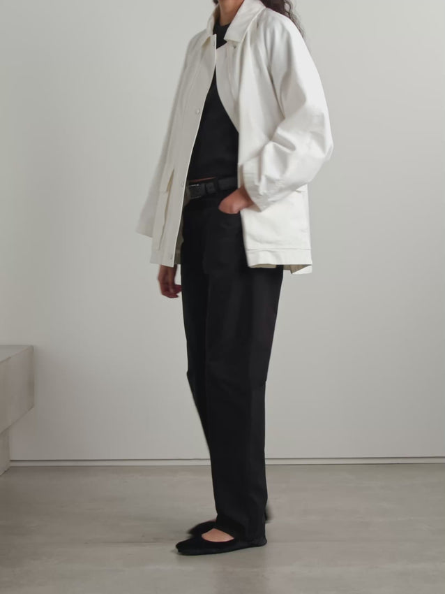 Inspired by timeless field jacket silhouettes, The Row's Elodianna combines heritage design with contemporary ease. Crafted in Italy from crisp white cotton-canvas, this piece features a relaxed, unstructured fit refined by adjustable waist toggles for subtle definition. Functional flap pockets offer convenient storage for essentials, while the understated aesthetic makes it an effortless layer for any occasion.